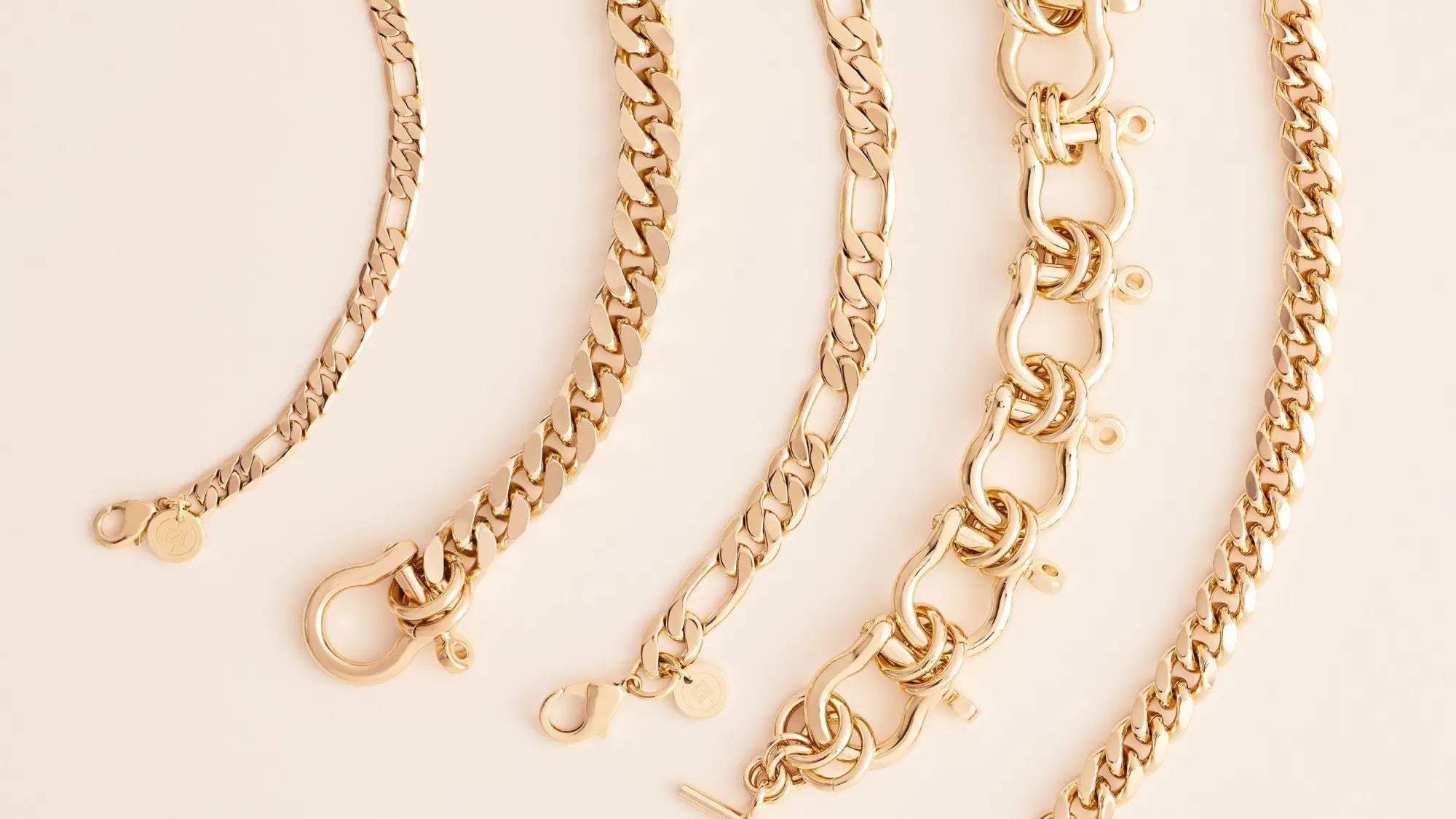 Gold-colored metal chain bracelets with various link styles and clasps in the Chain Bracelets collection