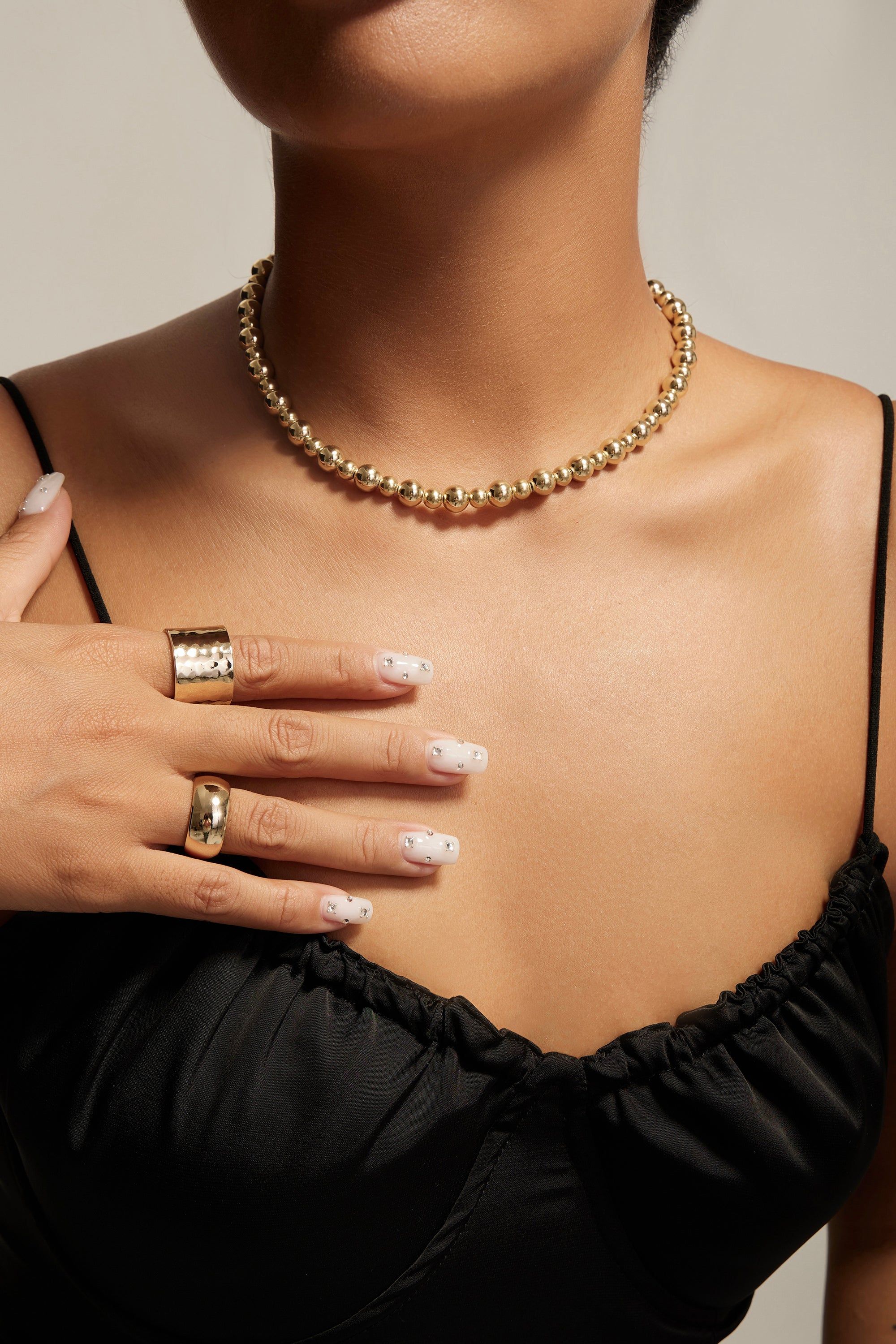 Gold beaded necklace displayed with a 9.5mm domed ring for stylish jewelry combo