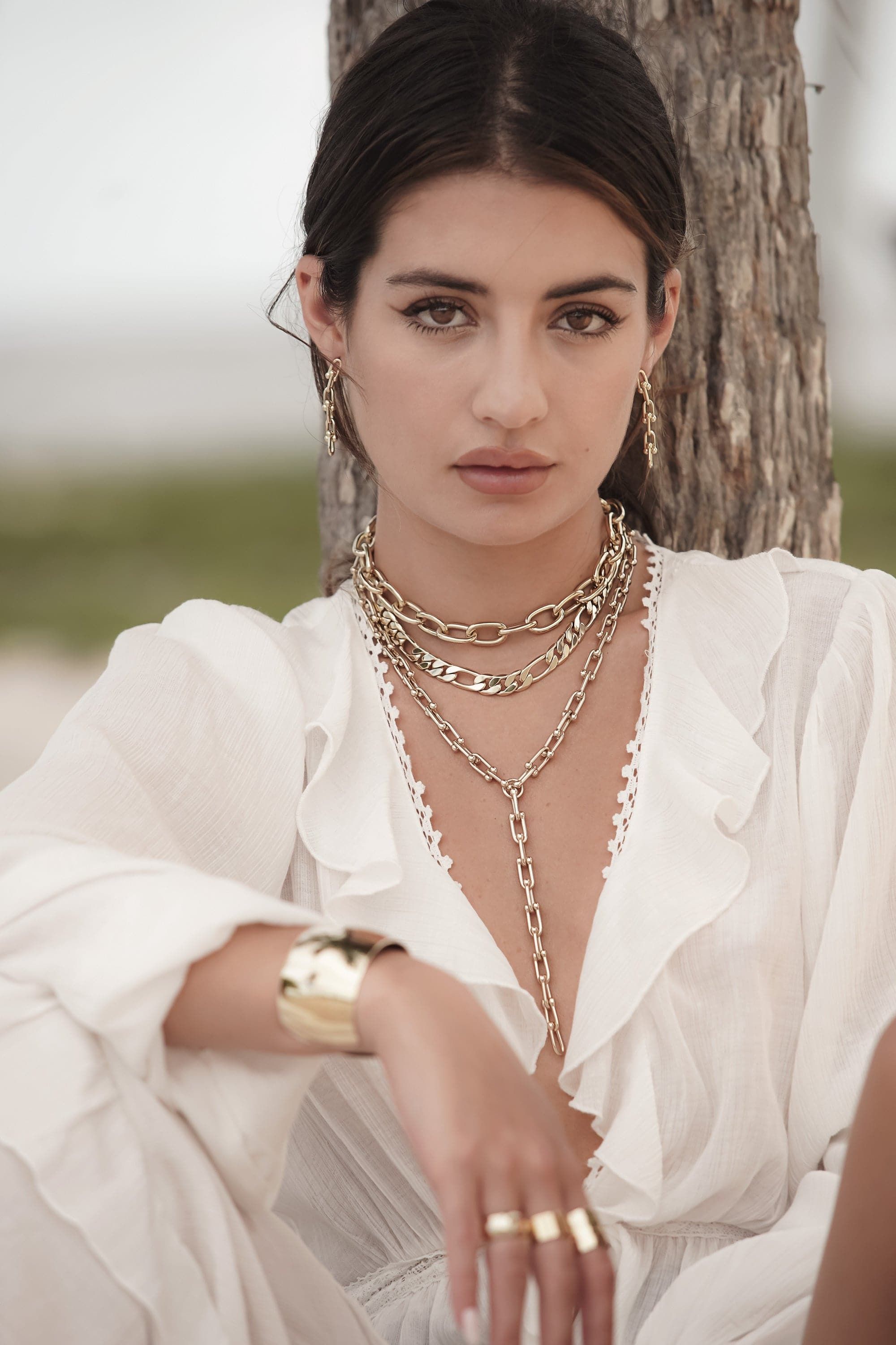 Woman wearing gorgeous gold Axel Necklace jewelry accessory for stylish looks