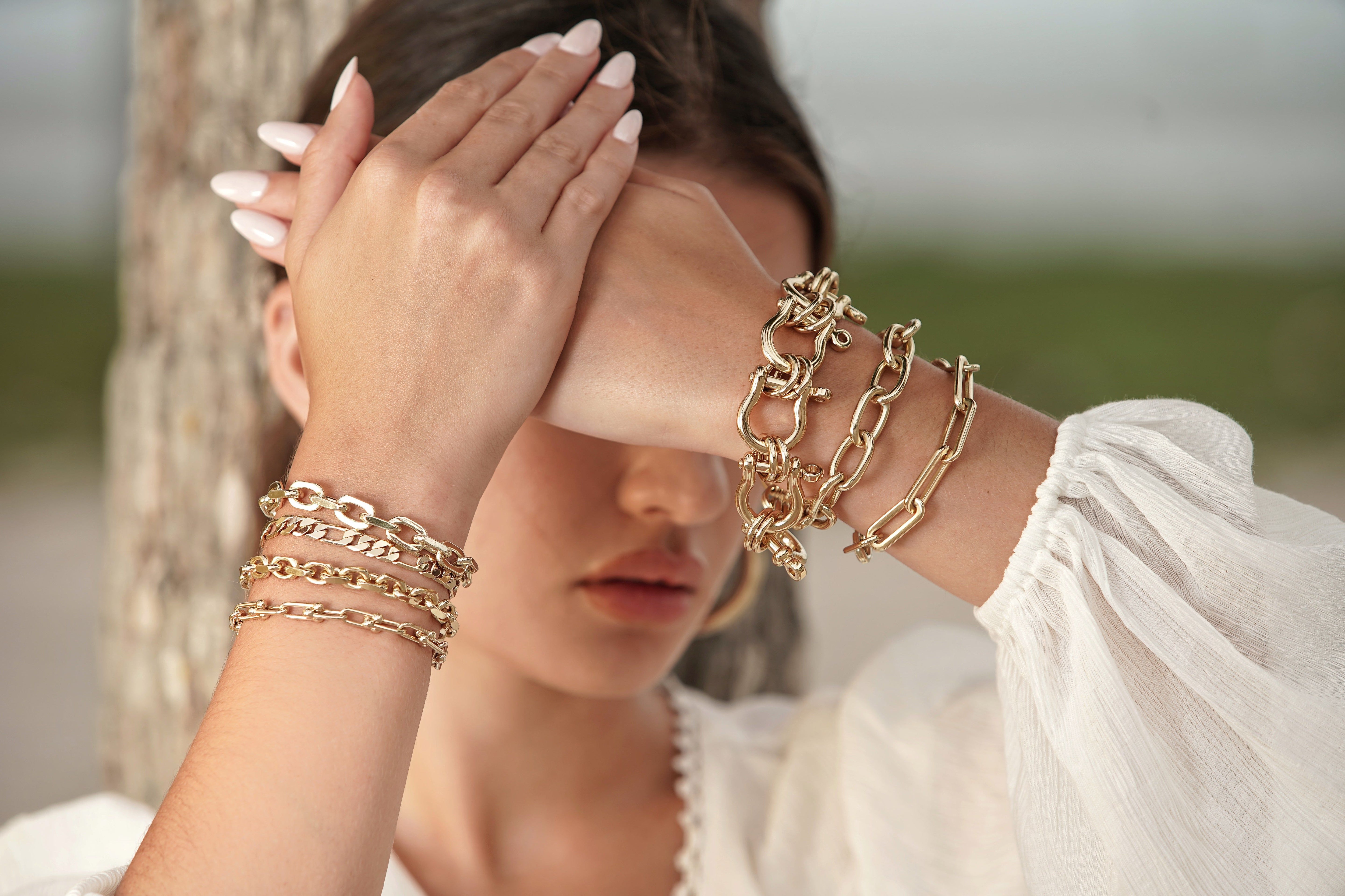 Shiny gold chain bracelets on the Alana Toggle Bracelet product display