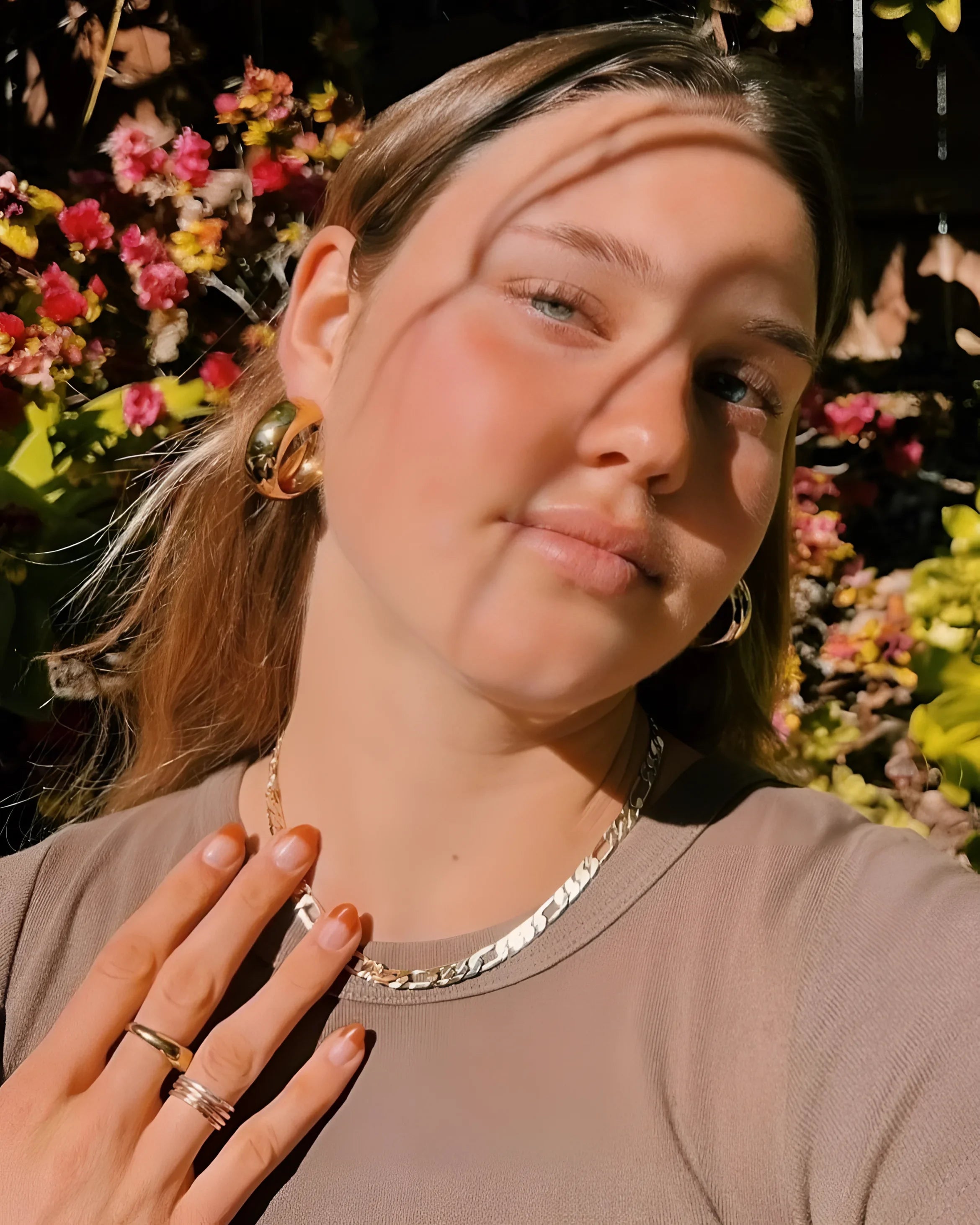 Cute young woman showing off her Baby Axel Chain Necklace in this portrait shot