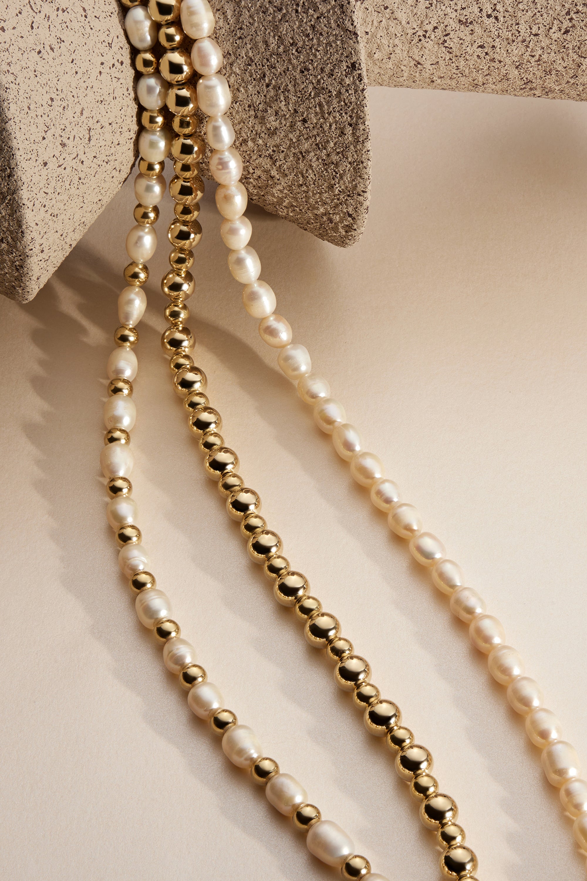 Beau Bead Necklace with three strands of pearl and gold beads for a stylish look