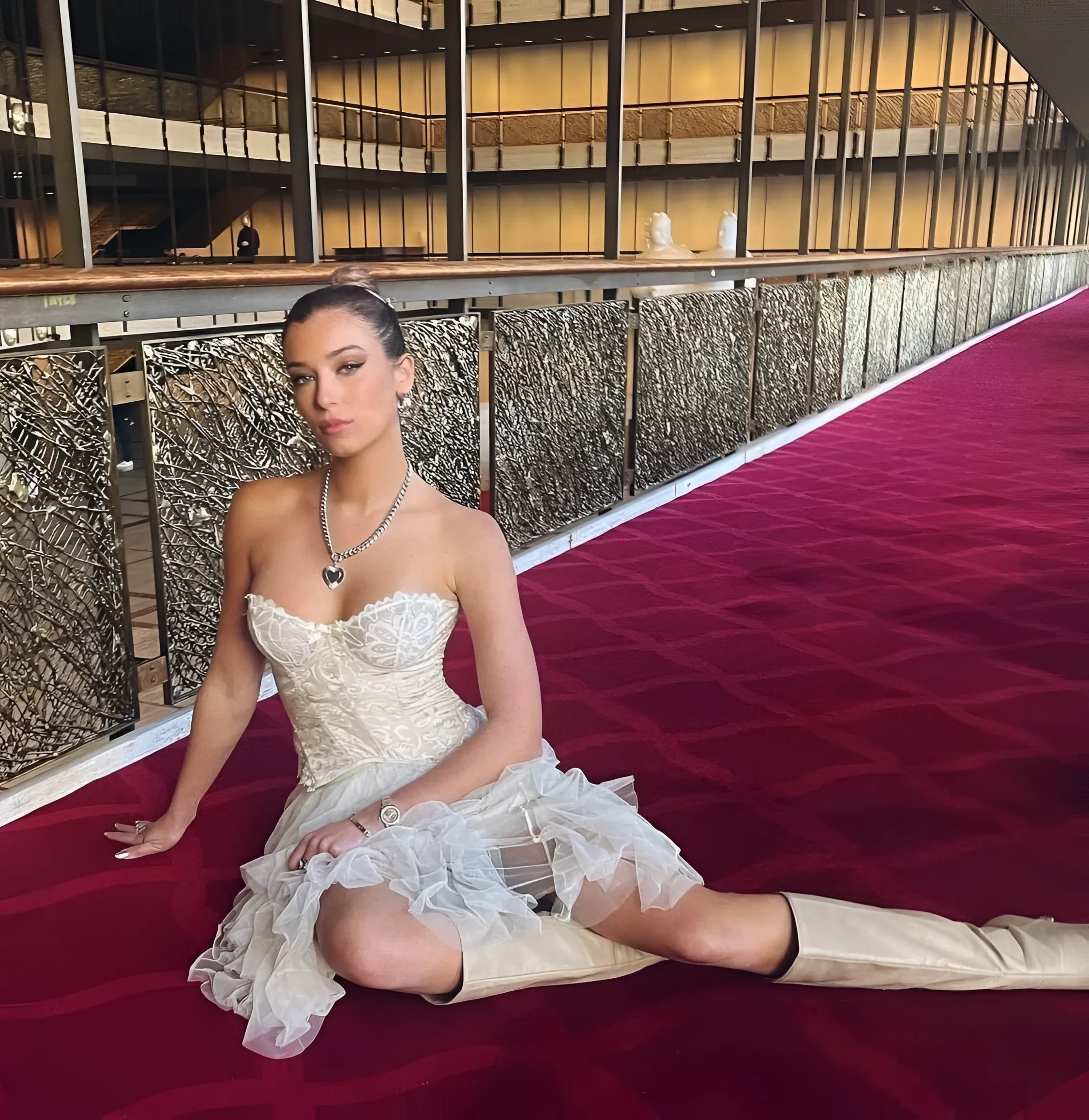 Woman in a white dress and boots wearing the Curb Chain & Heart Pendant Necklace