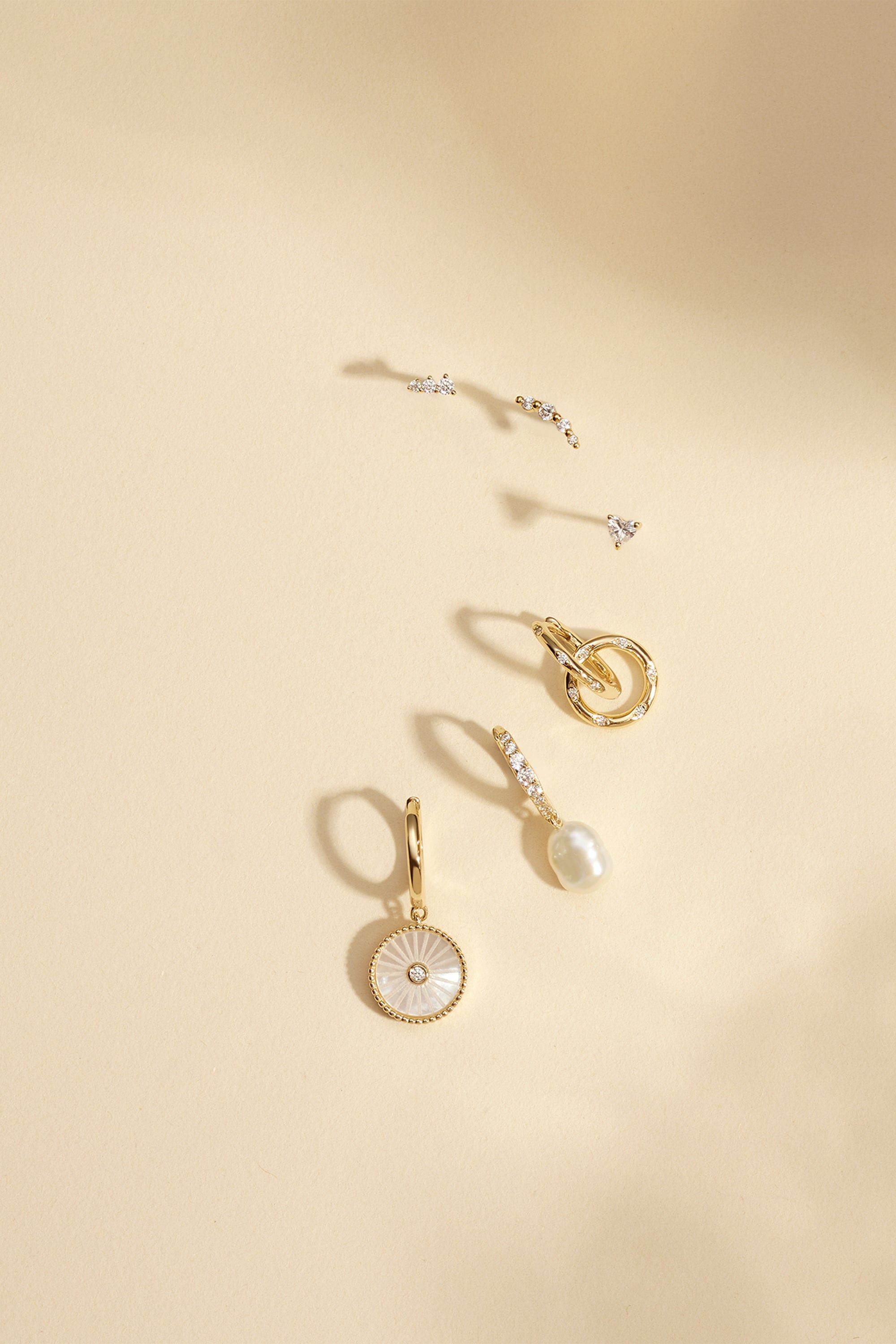Assorted earrings from CZ Huggie Hoops With Pearl Drop jewelry collection