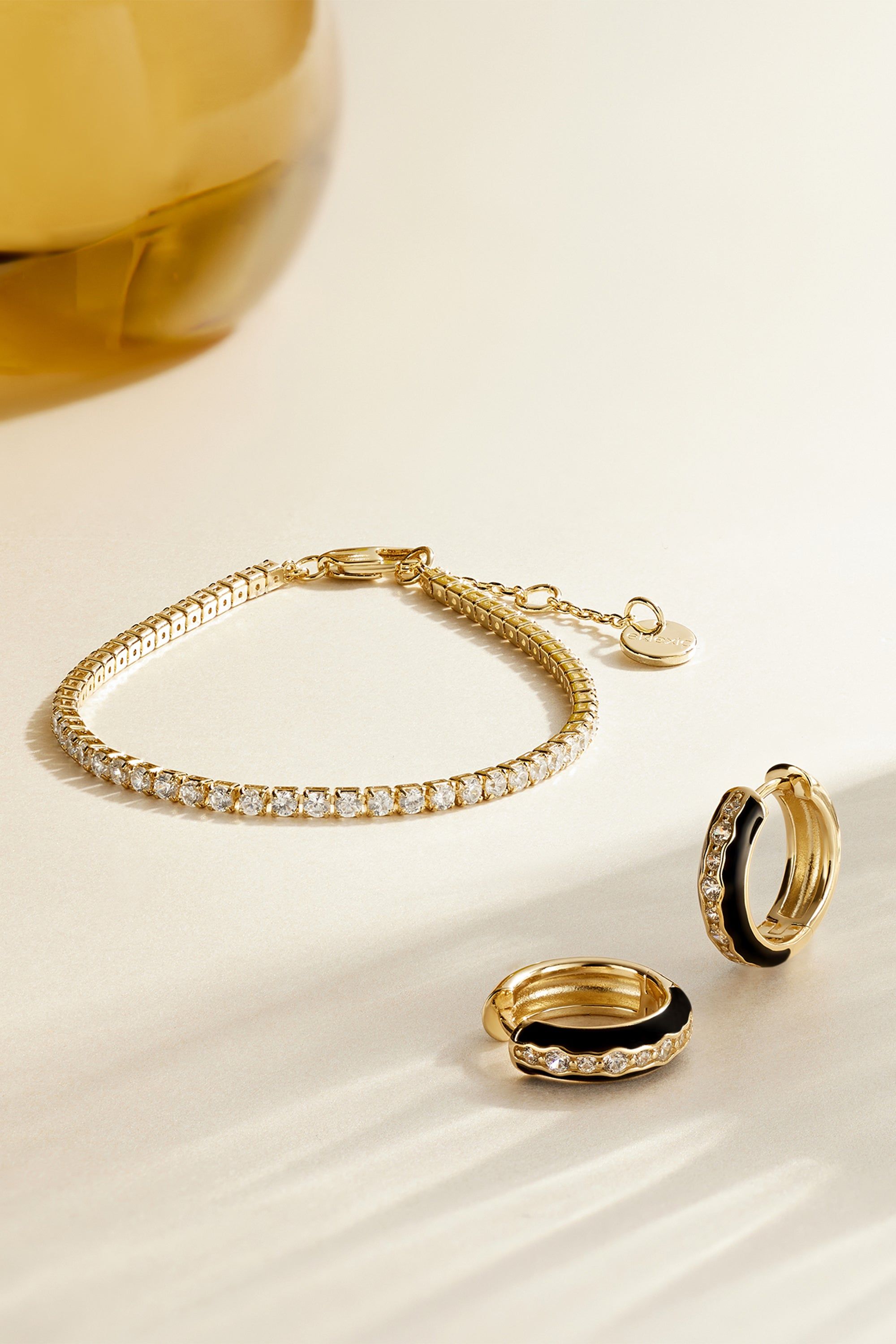 Shiny Gold Bracelet and Hoop Earrings on the Classic CZ Tennis Bracelet product display