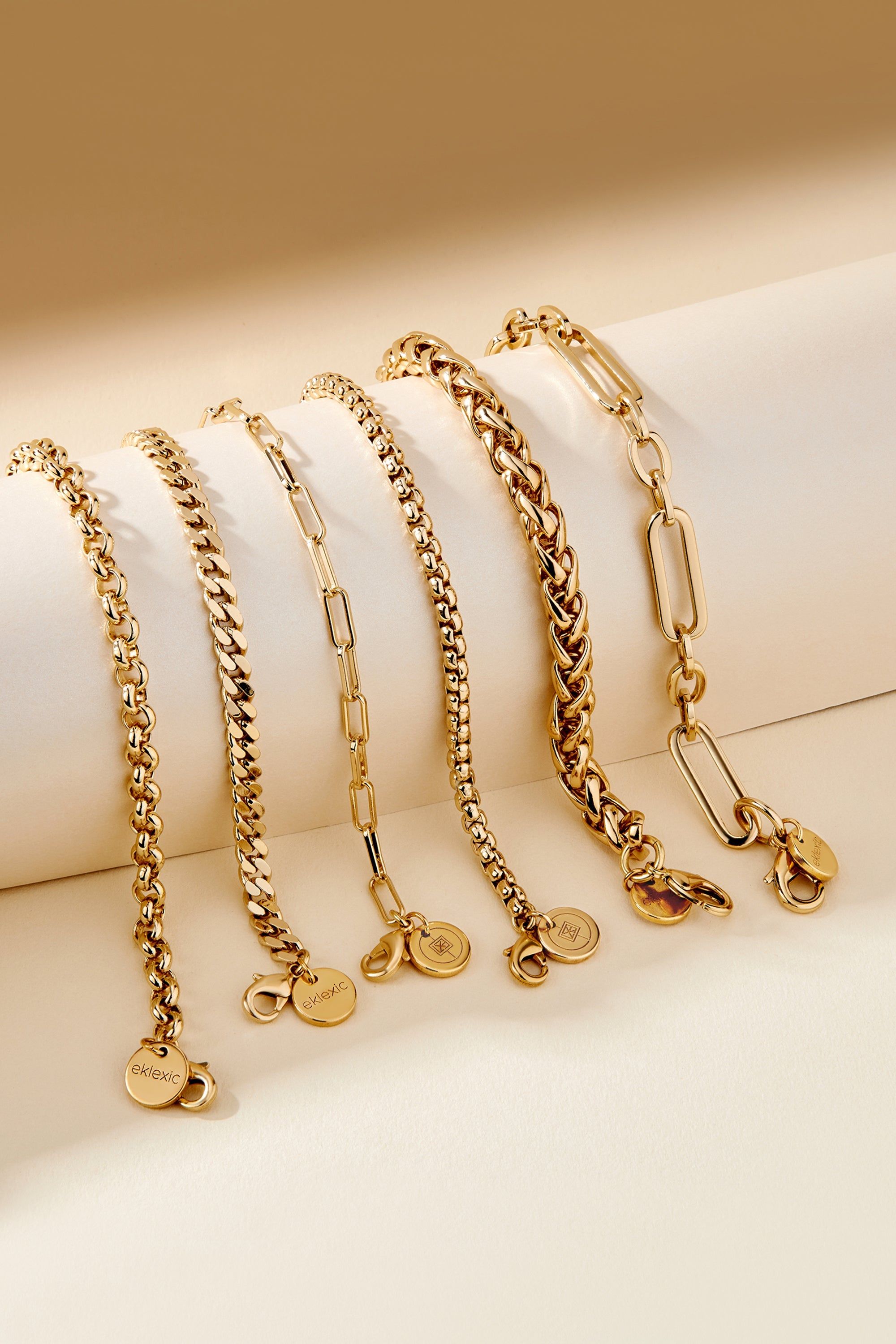 Gold-toned Dean Bracelet with chain and circular charms on a stylish display