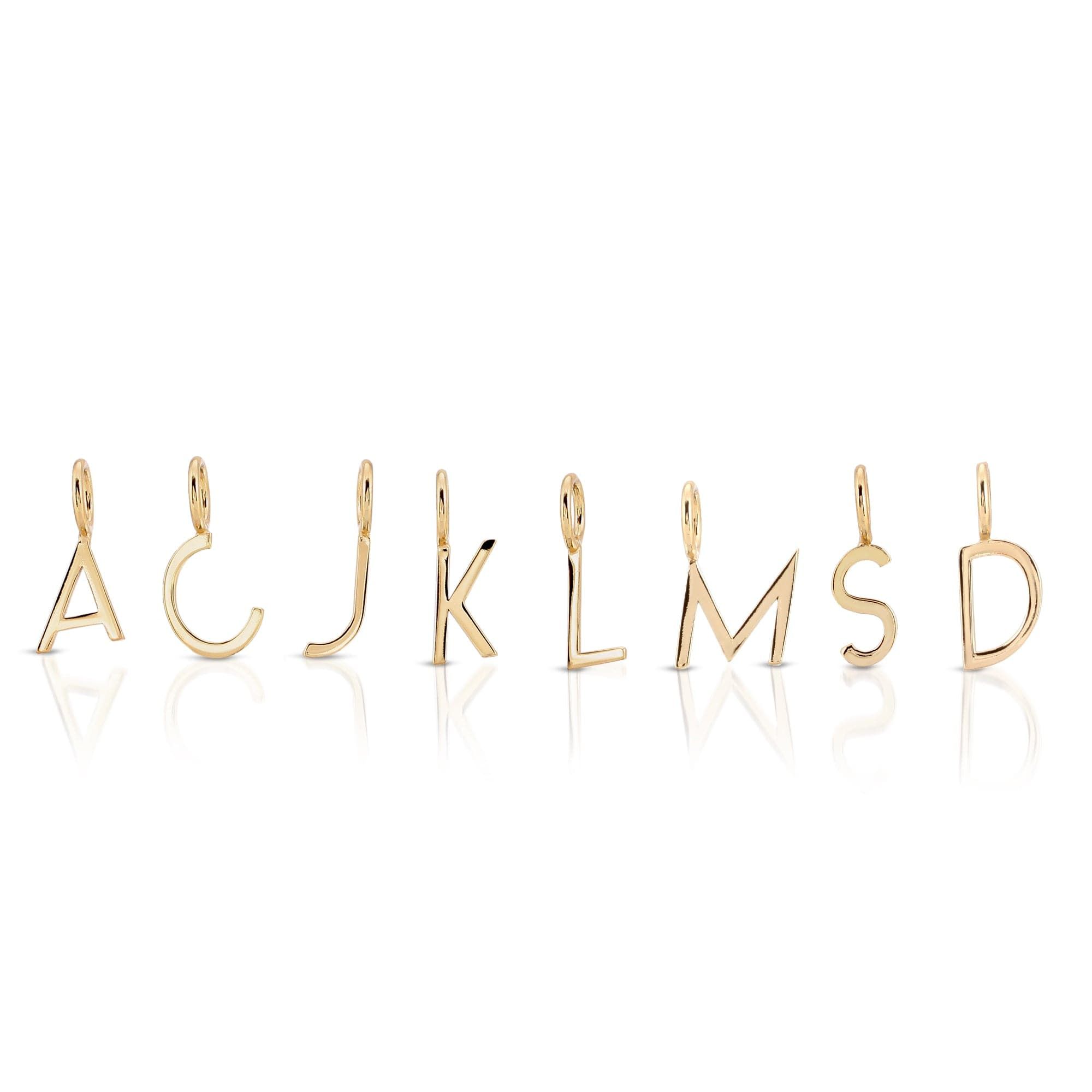 Gold letter pendants from Essential Letters hanging on a chain, perfect for personalized jewelry