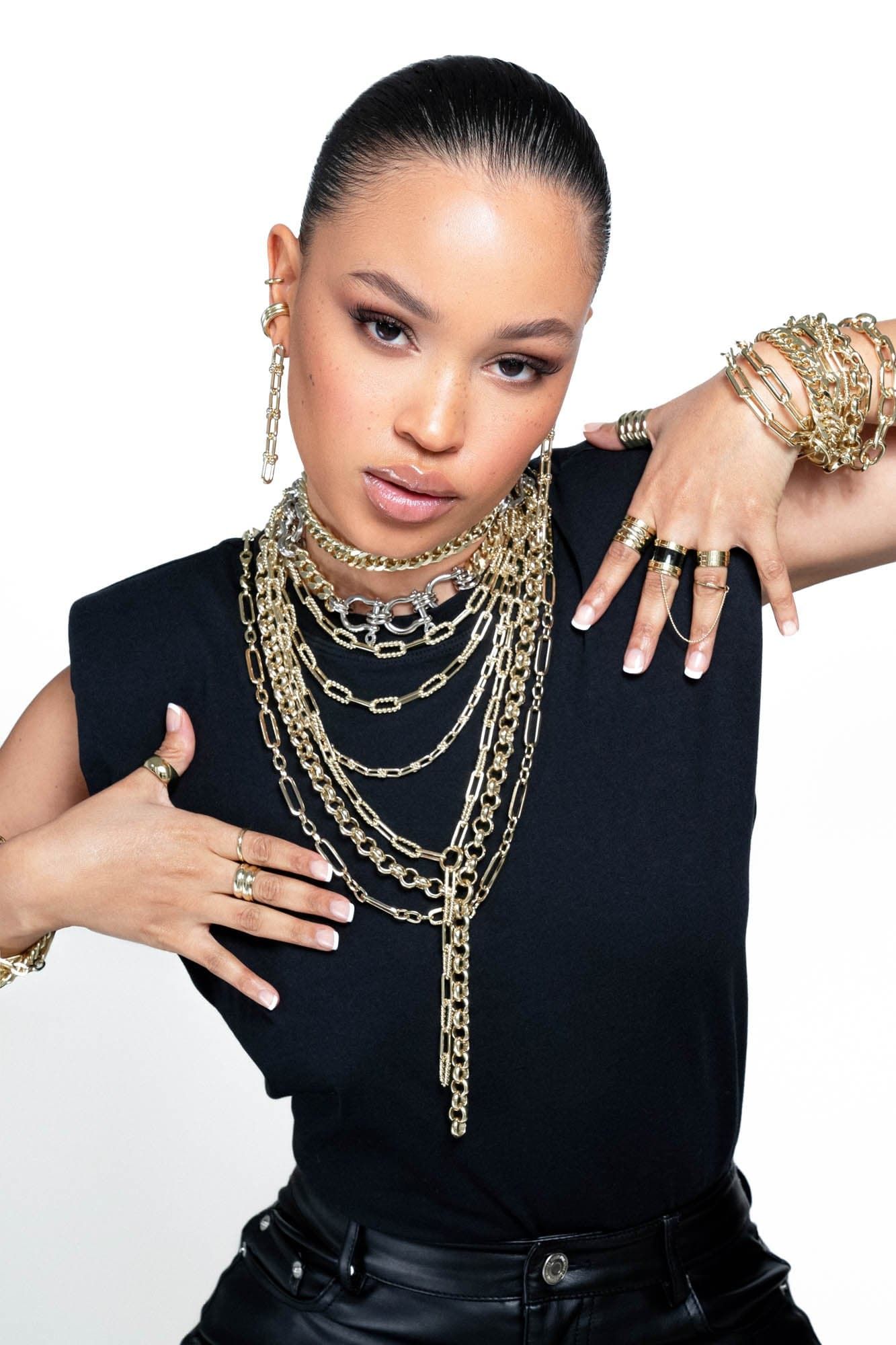 Woman wearing the stylish Enzo Bracelet with gold jewelryowd