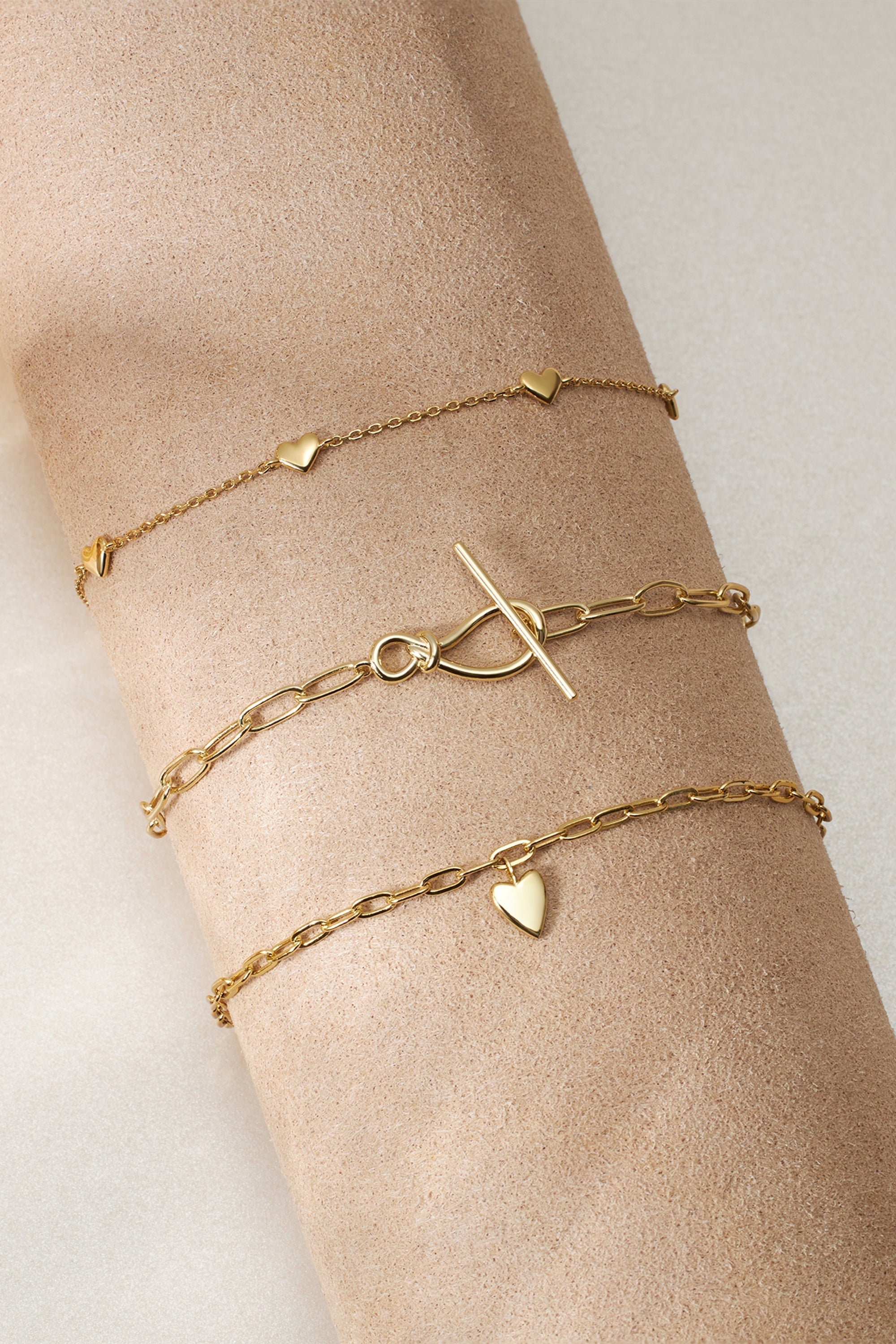 Gold-toned layered bracelets from the Knot Toggle & Paperclip Chain Bracelet collection