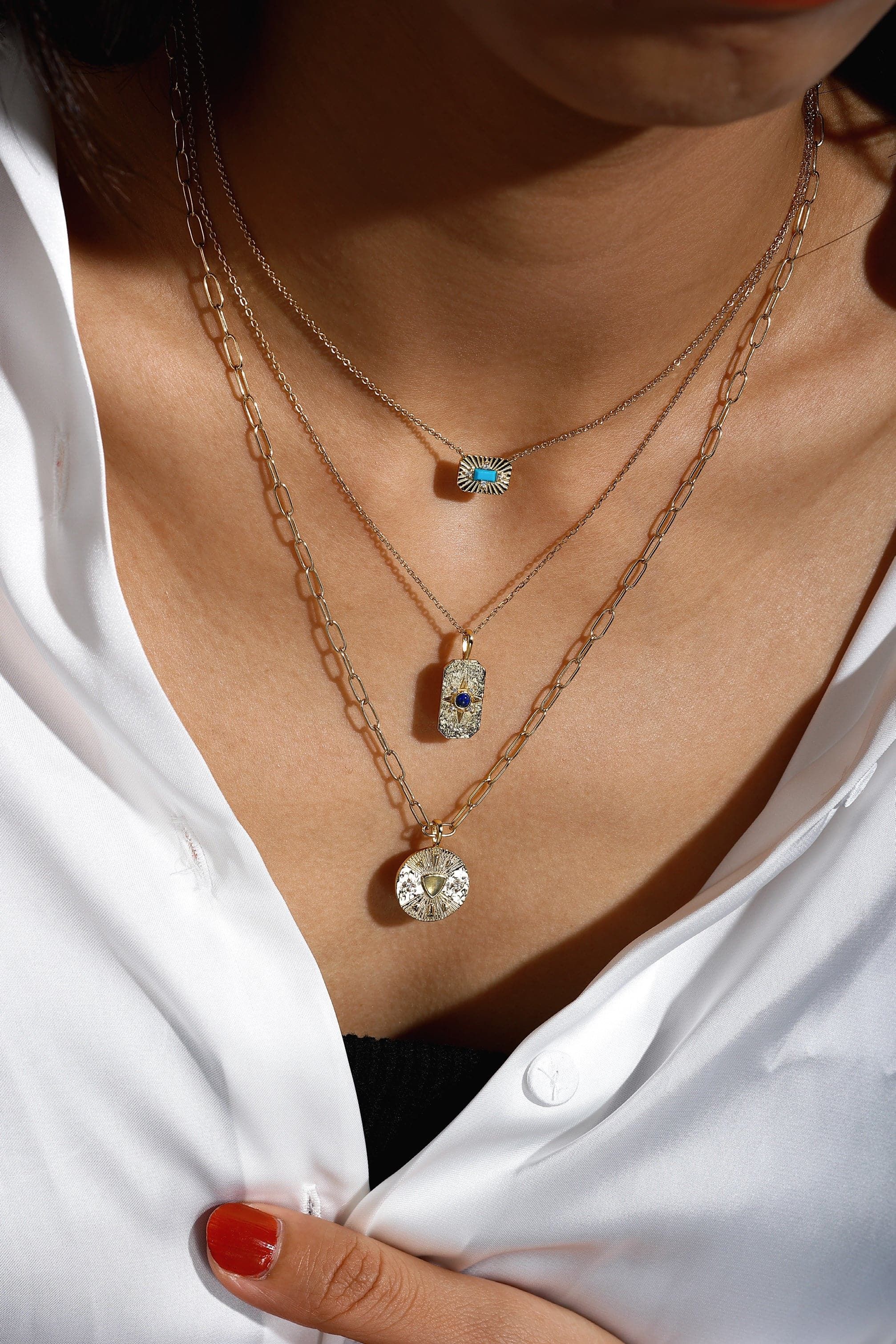 Layered gold necklaces with starburst and turquoise pendants perfect for stylish looks
