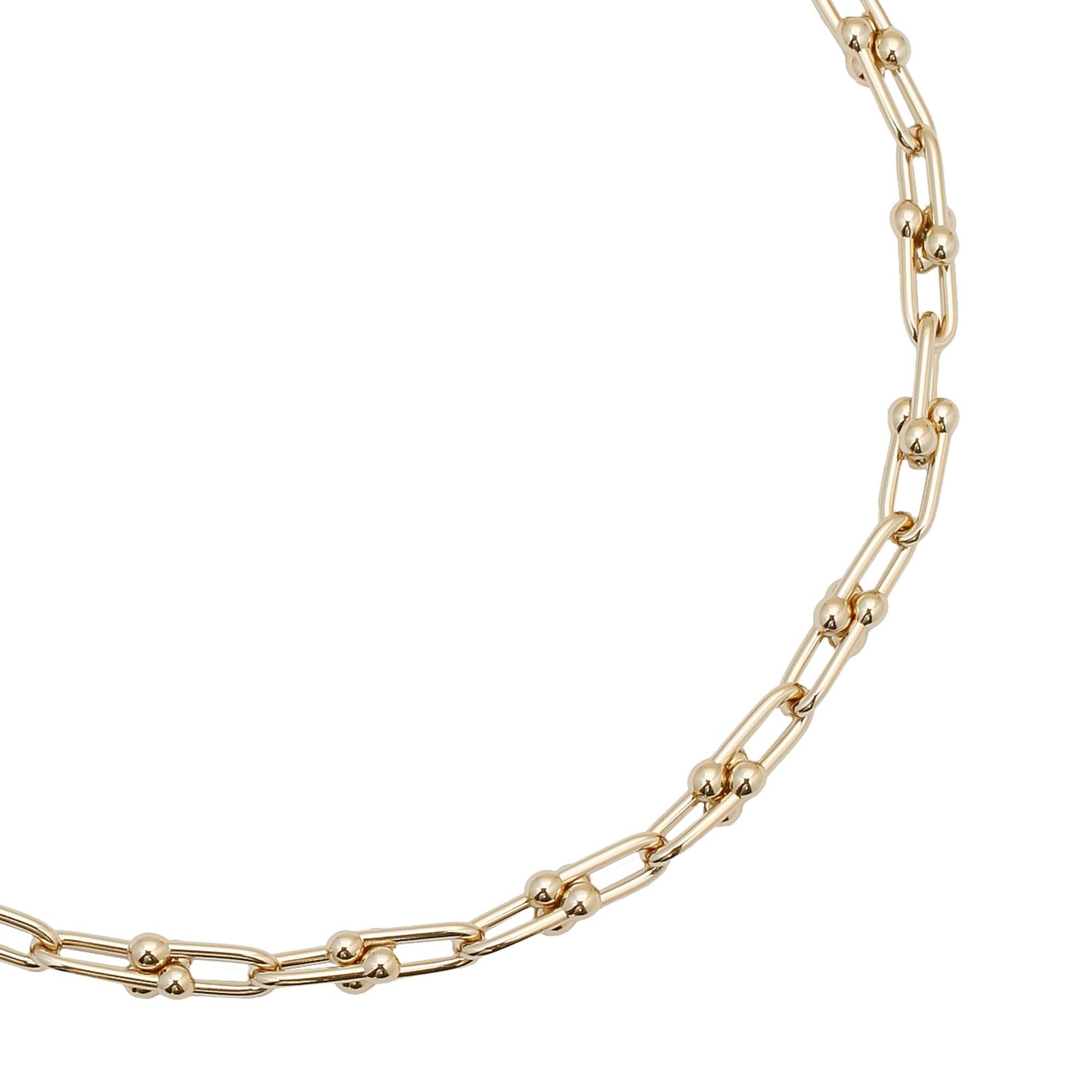 Small Margaux Necklace featuring a gold chain link bracelet with spherical accents