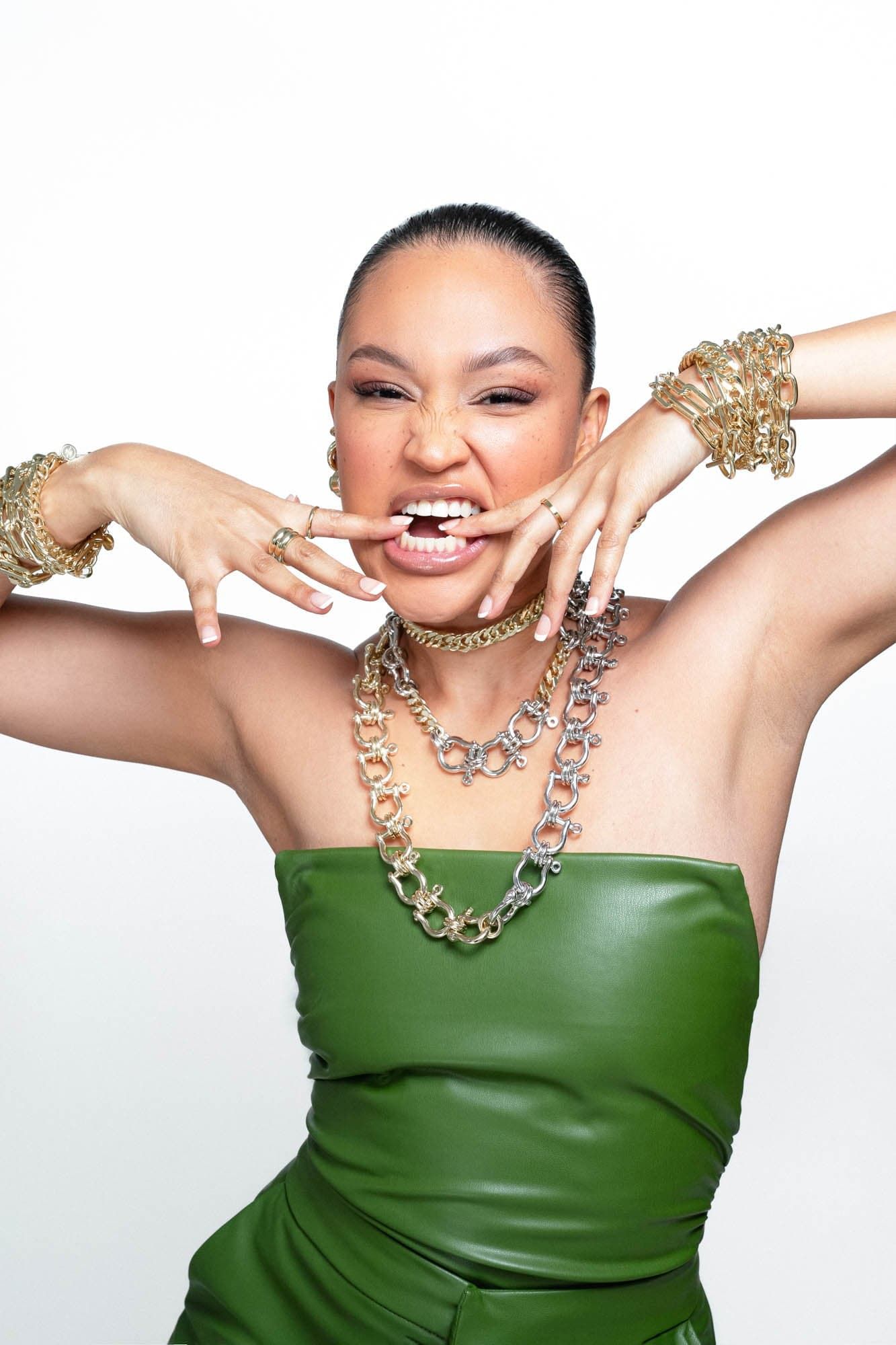 Woman in green top showing off Two Toned XL Harrison Necklace with gold jewelry