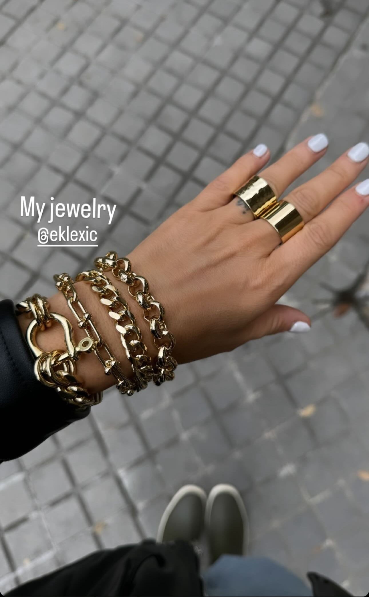Gold jewelry on hand showcasing the stylish Violet Bracelet accessory