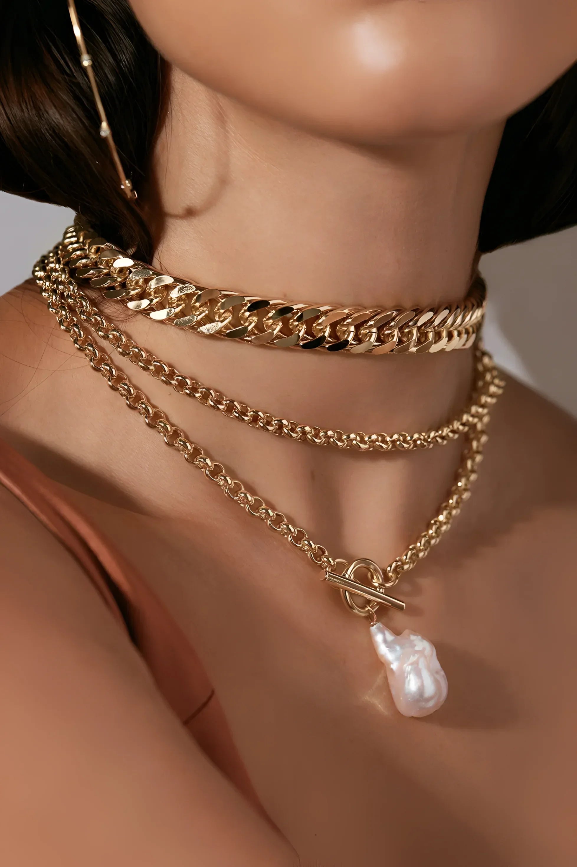 Arya Necklace with layered gold chains and baroque pearl pendant from Slinky Curb Chain layering collection