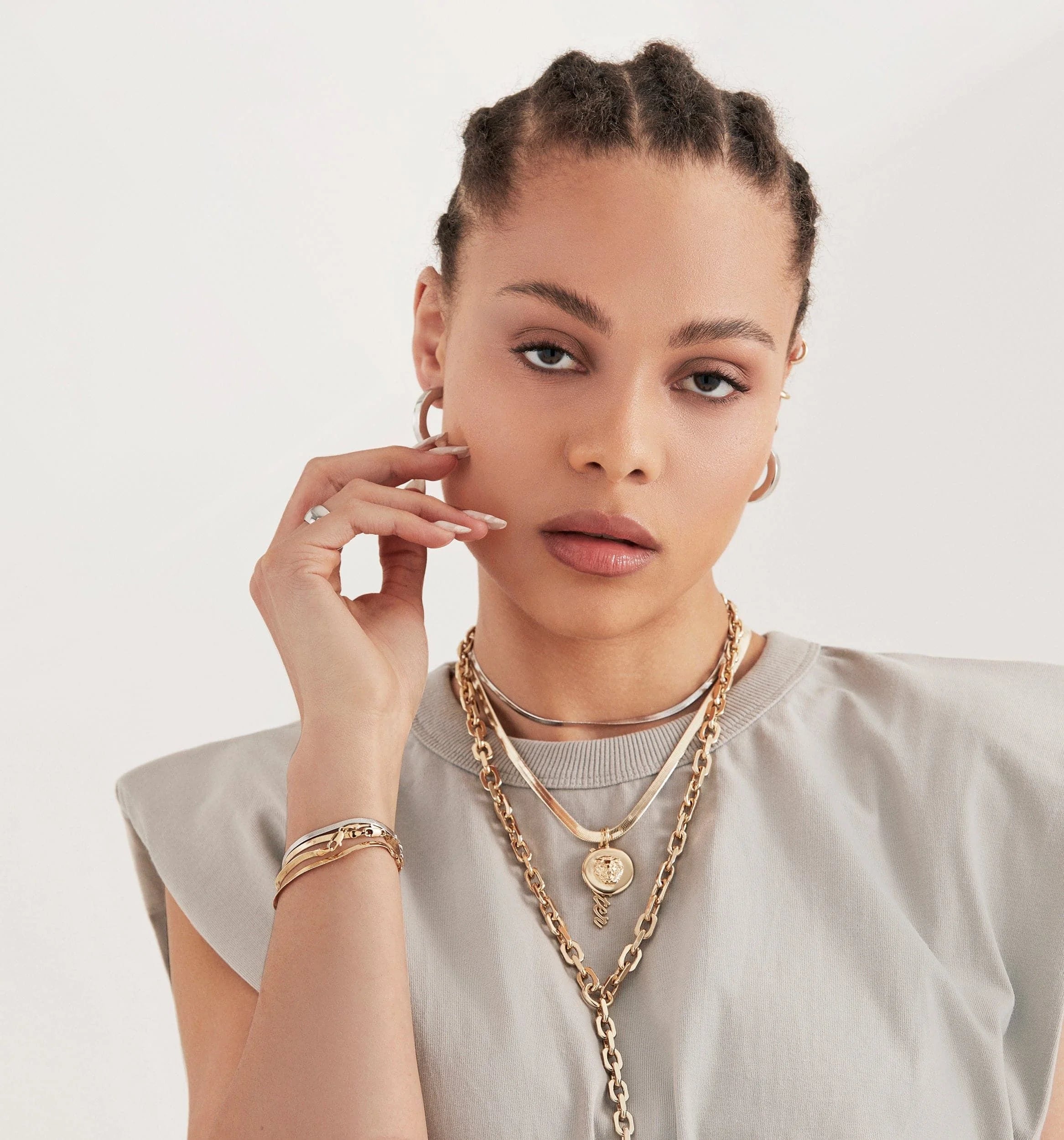 Woman wearing the Leni Lion Pendant, a recycled brass lion head pendant jewelry piece