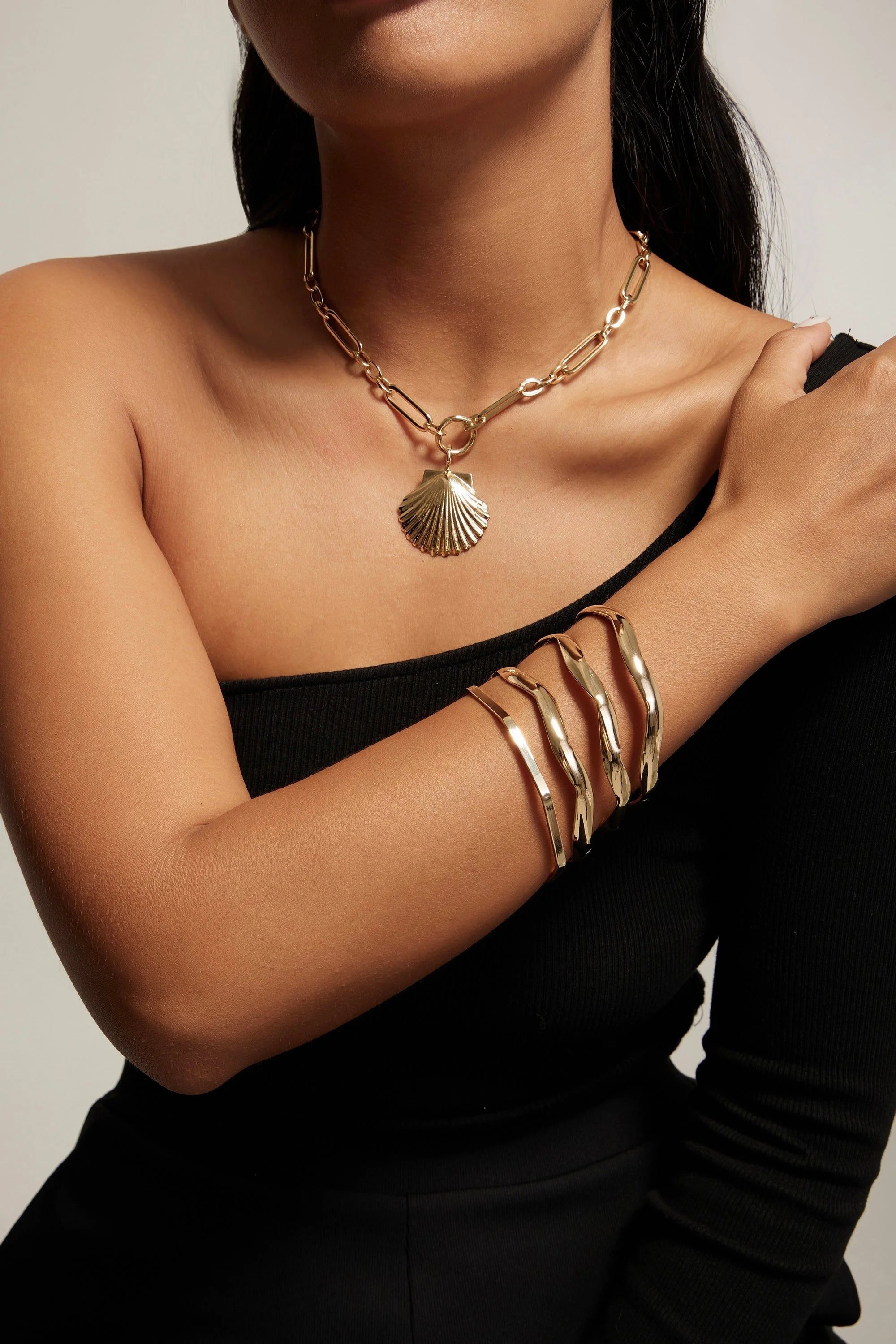 Gold seashell necklace and bracelets made with recycled brass and 14k gold plated ecoat
