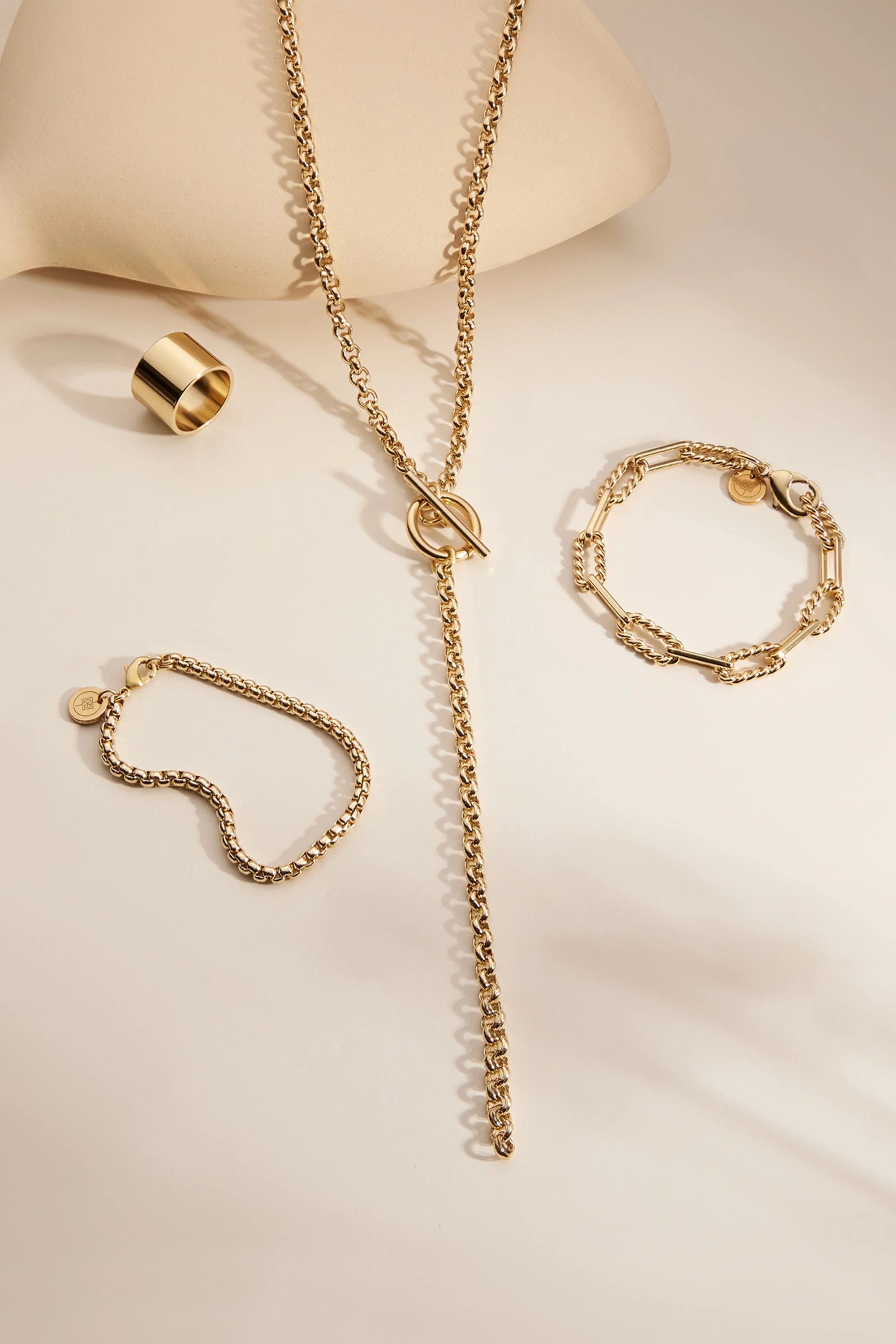 Gold-toned jewelry set featuring recycled brass plating and a clear protective coating as a statement piece