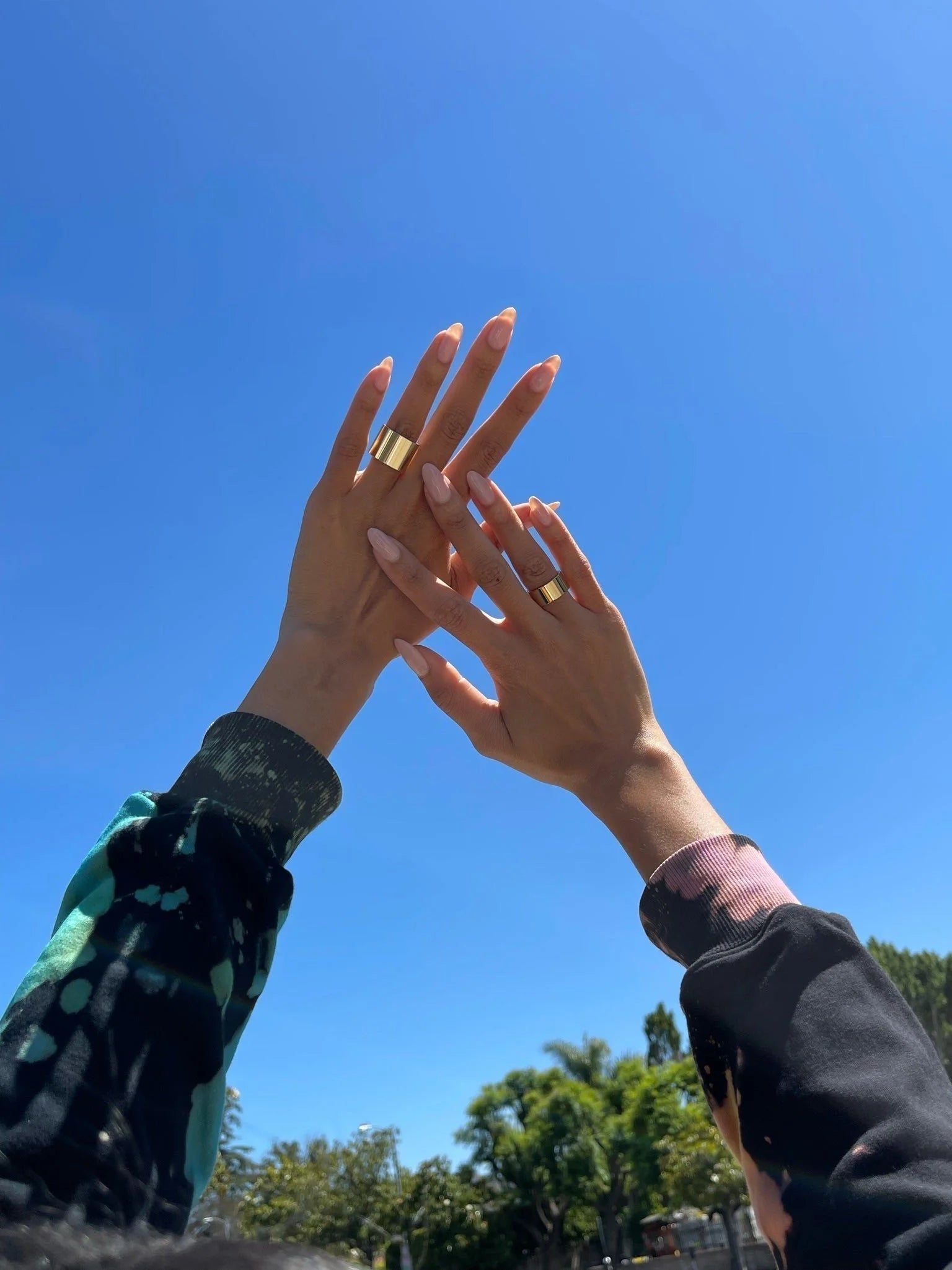 Two hands wearing Thick Flat Ring with recycled brass plating and clear protective coating