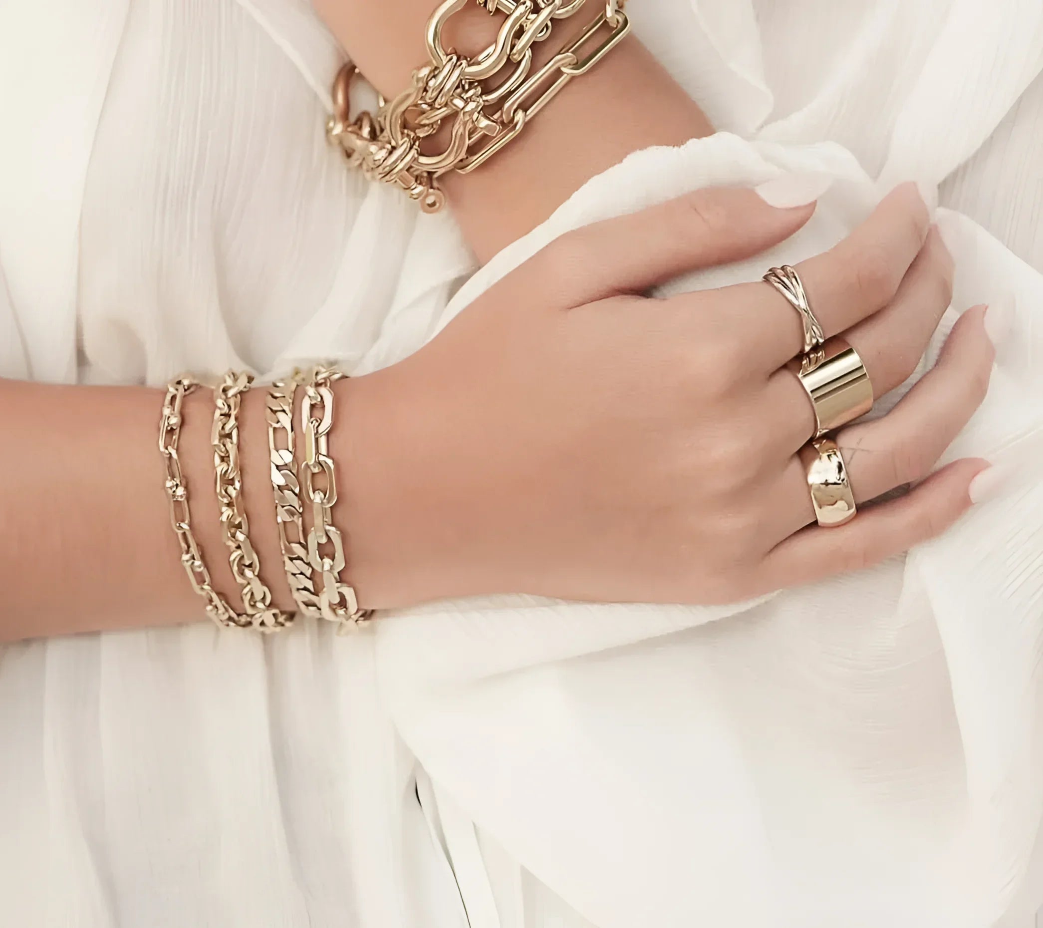 Gold-toned jewelry on hand featuring the two toned triple domed roll ring for stylish wear