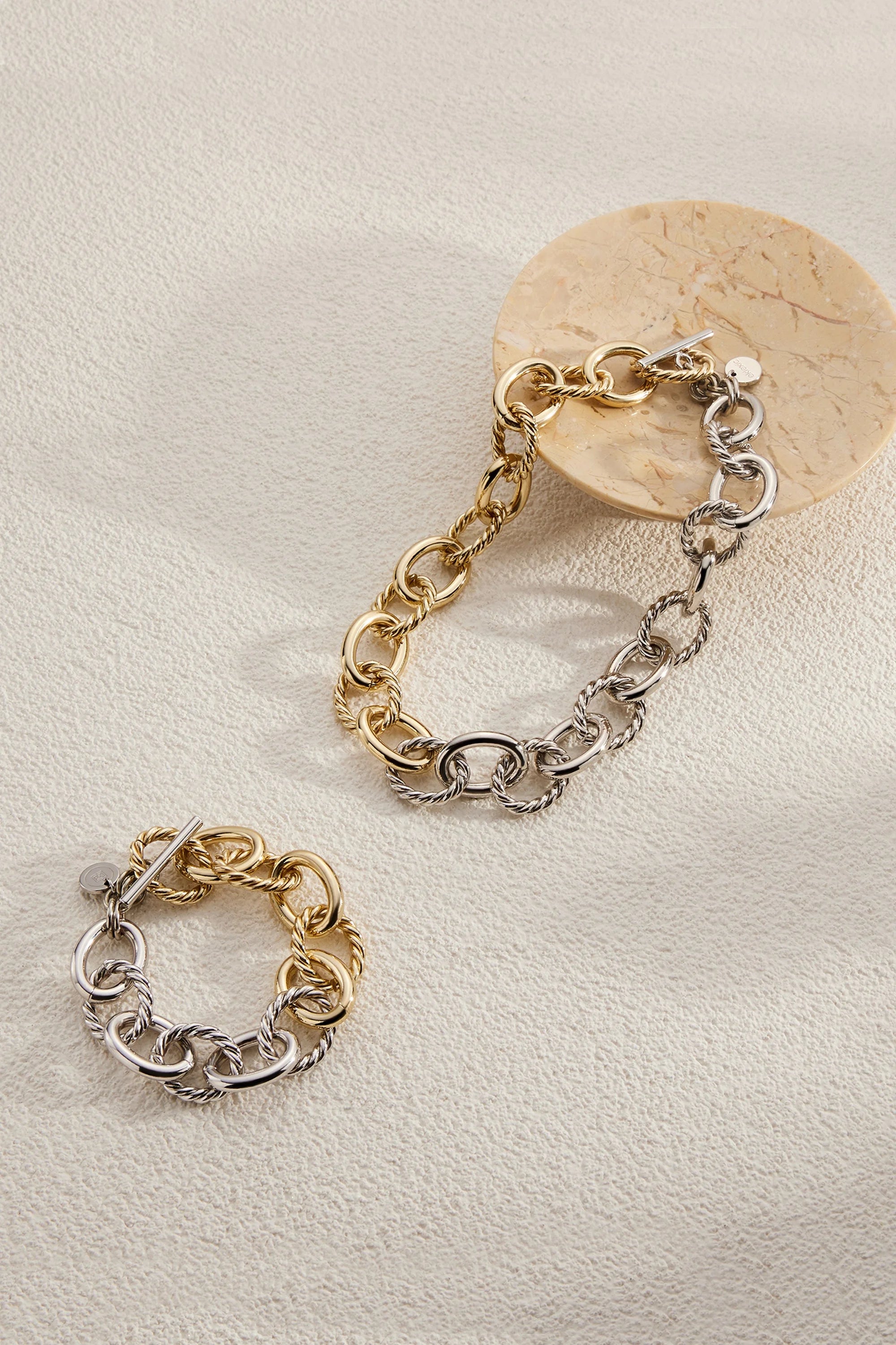 Two-tone chain bracelets with recycled brass, 14k gold, and rhodium plating display