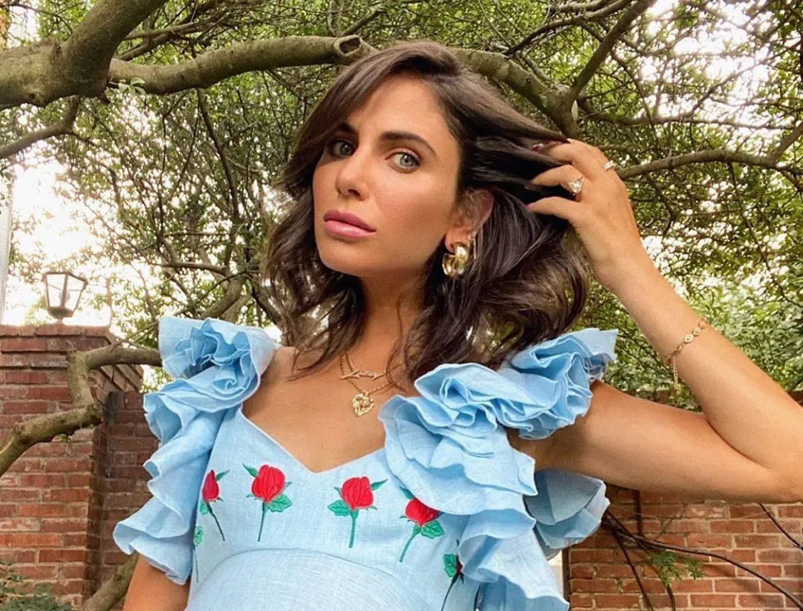 Woman in a light blue floral dress wearing gold hoop earrings for everyday wear