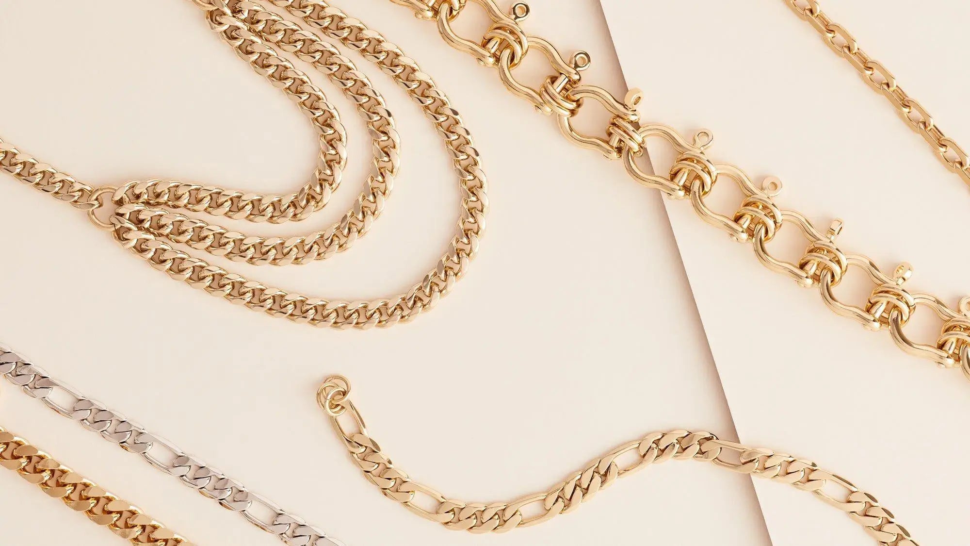 Assortment of gold and silver chain necklaces and bracelets from EYEWEAR CHAINS collection