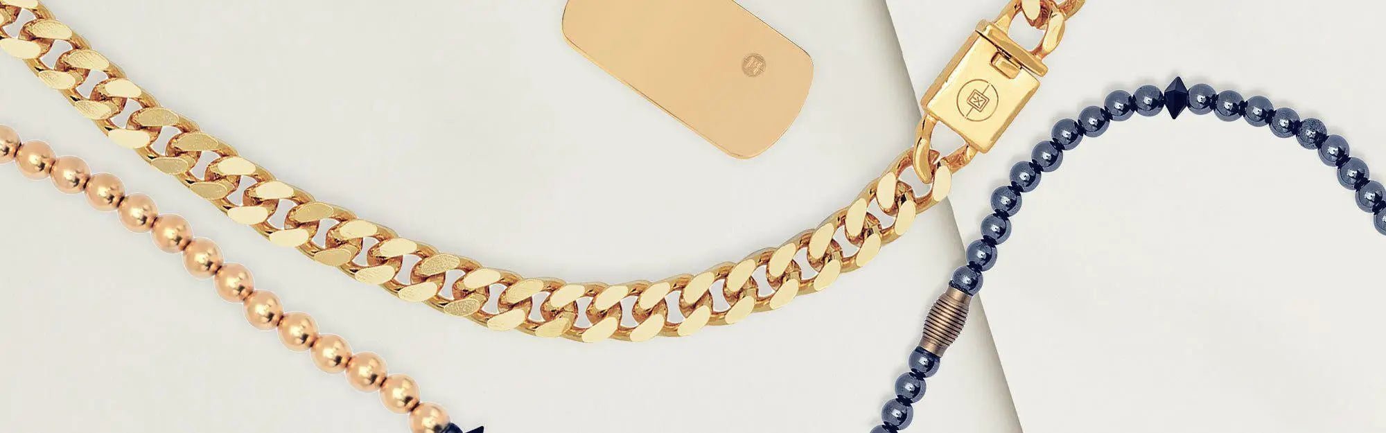 Men’s necklaces collection featuring a thick gold chain, a beaded gold chain, and a dark beaded necklace