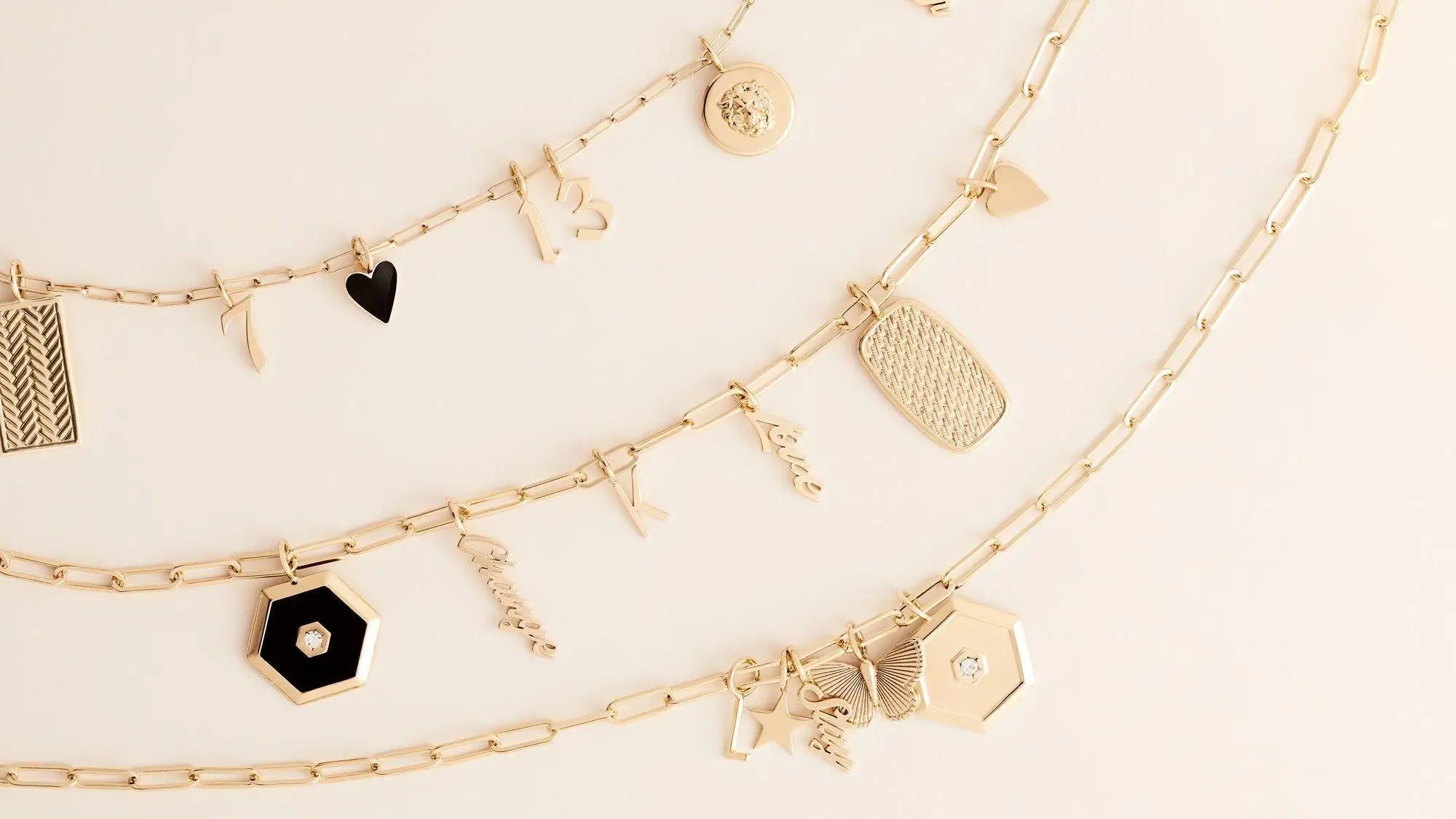 Three golden charm necklaces with various pendants in the Personalized Jewelry collection