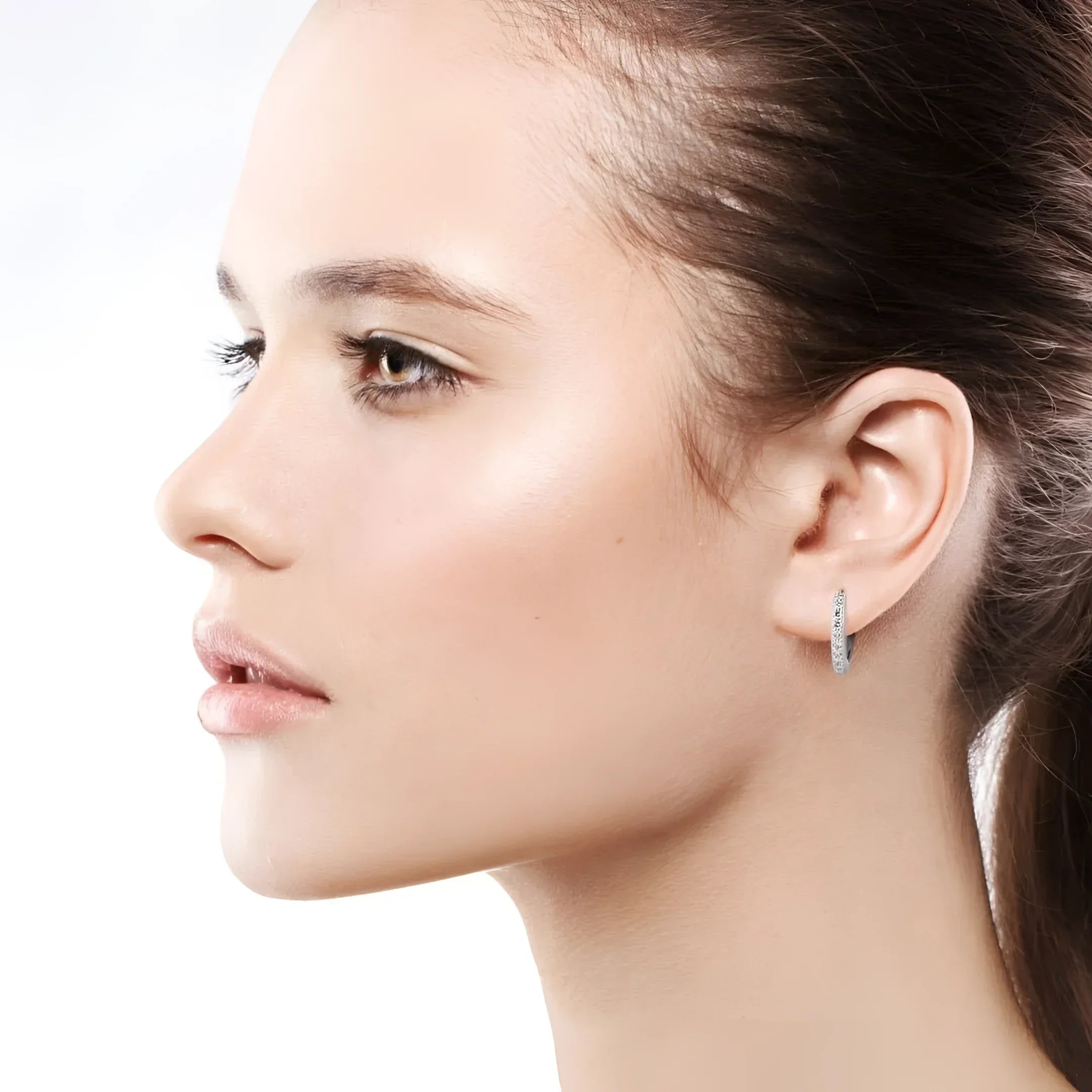 Woman wearing hoop earrings in 14k white gold, fine jewelry huggies, custom made