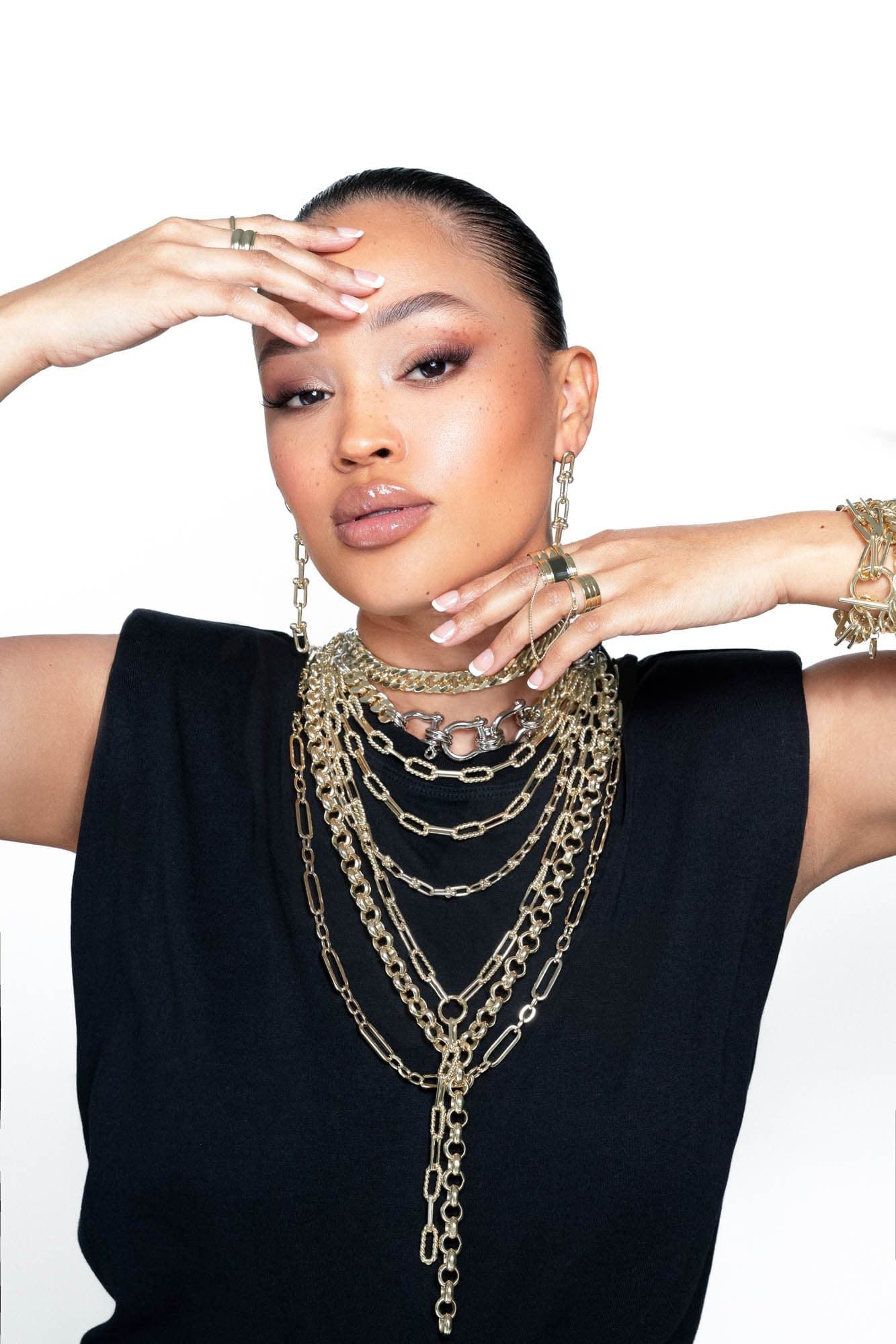 Woman wearing the stylish Dean Necklace with layered gold chains