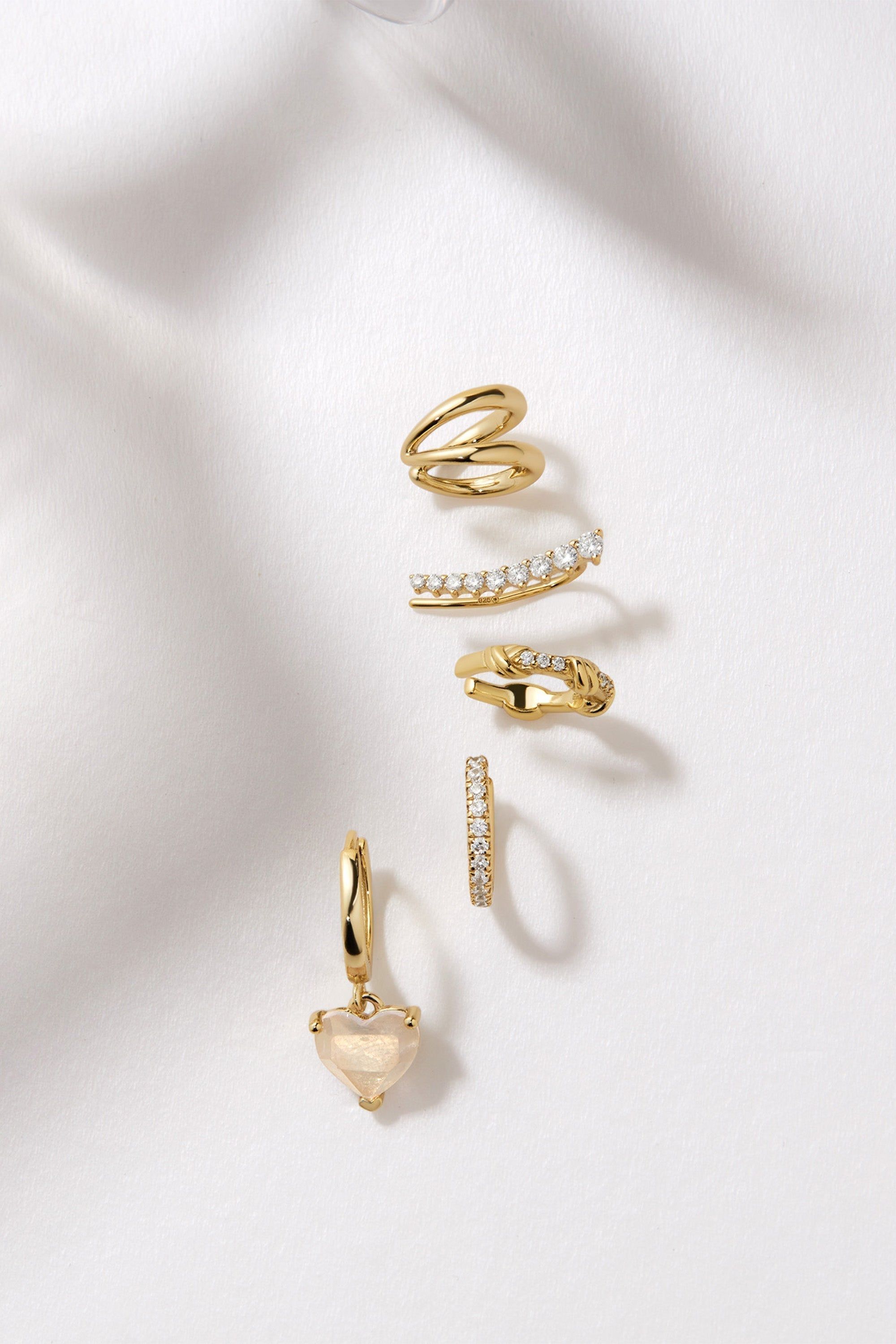 Gold-toned earrings and ear cuffs from the Graduated CZ Bar Ear Crawl jewelry set