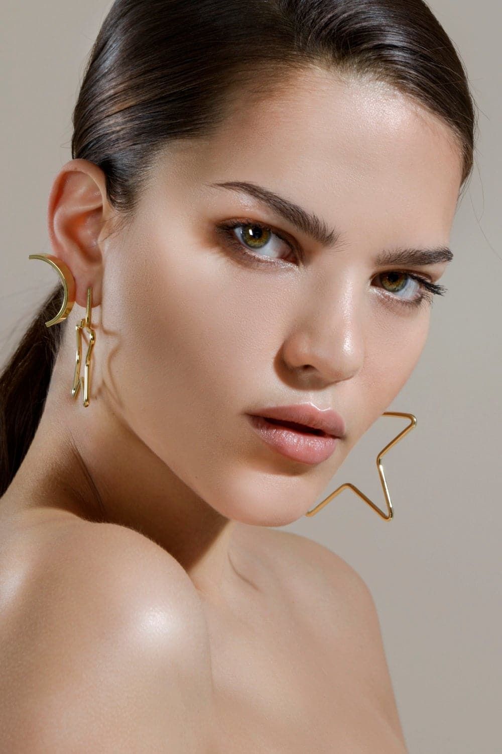 Woman wearing large gold full star earrings, perfect celestial jewelry vibe