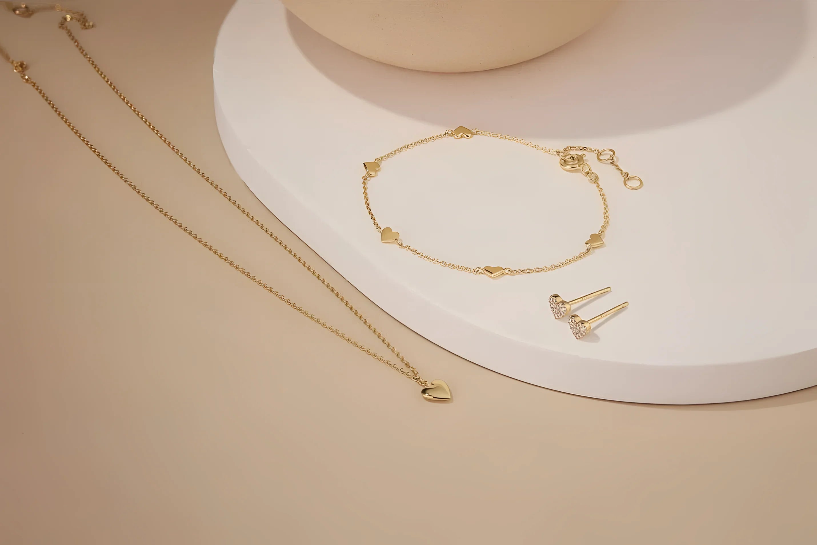Gold jewelry set featuring the Micro Heart Charm Necklace for a stylish look