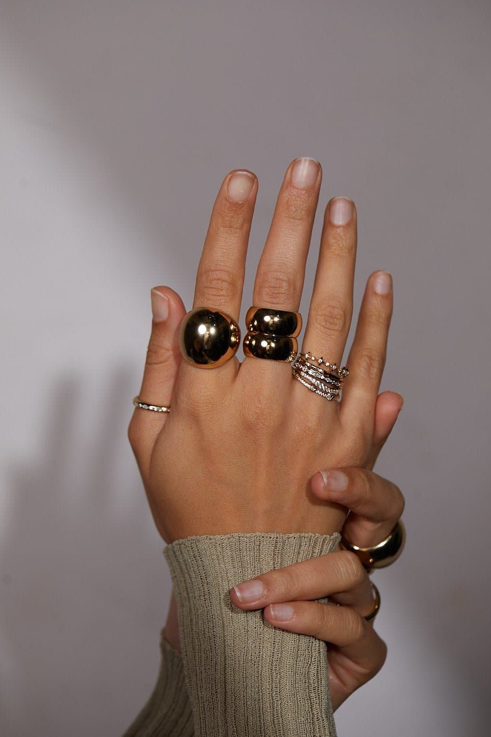 Hands with multiple rings featuring colorful CZ stones, perfect for stacking or every day style
