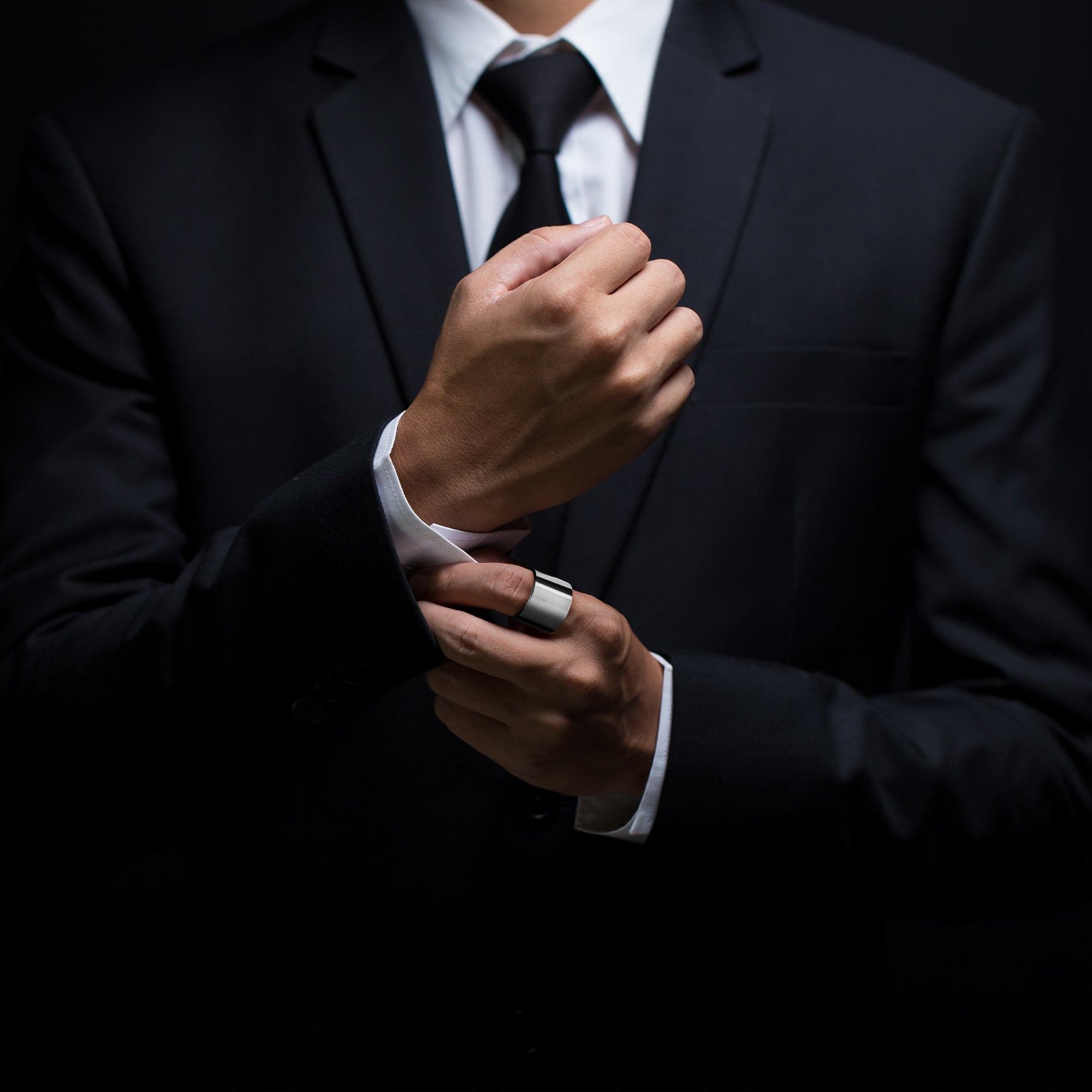 Man in a black suit wearing Men’s Thick Flat Ring showing style and elegance