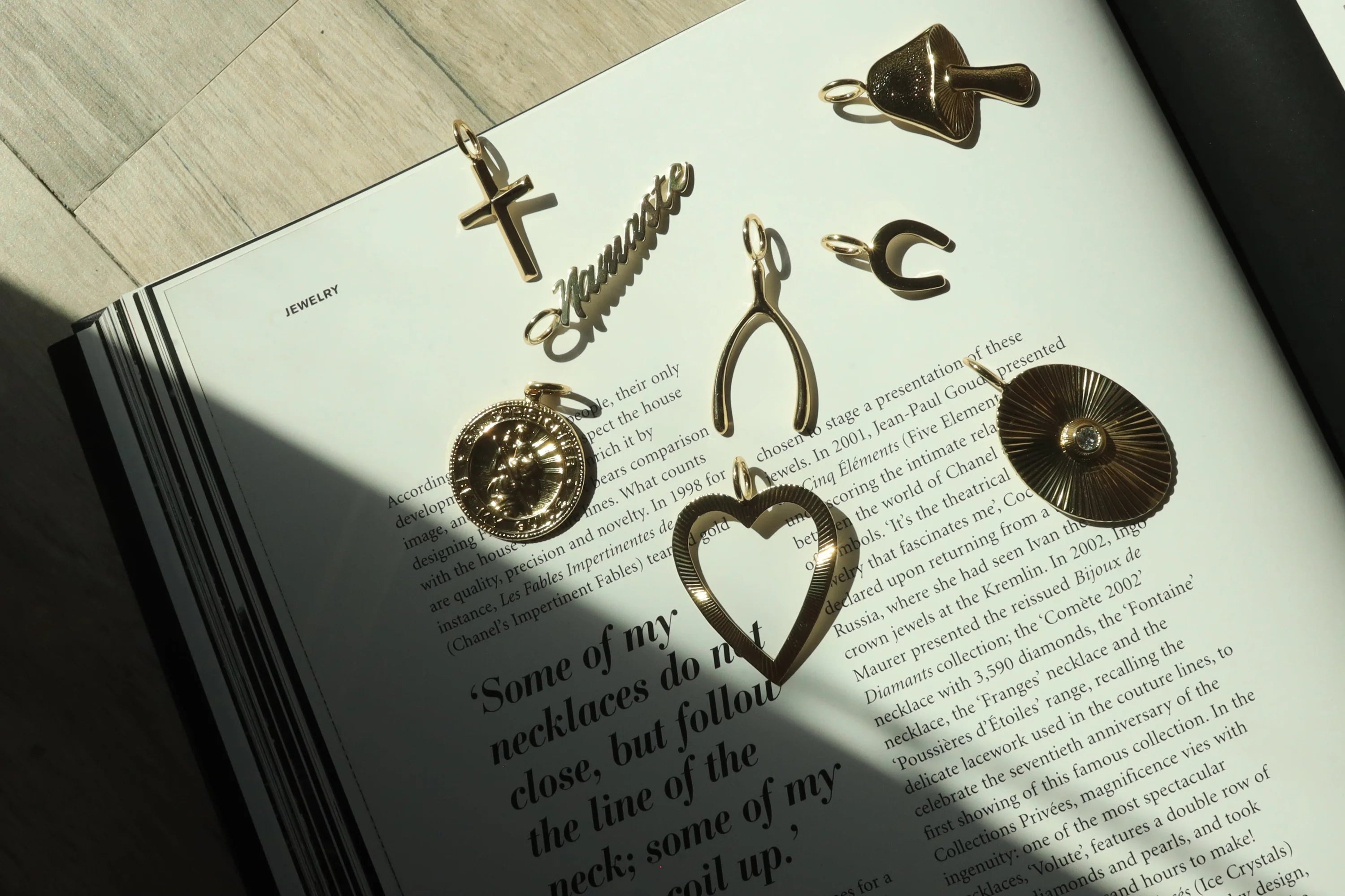 Gold-colored cross pendant with recycled brass finishes and rhodium plating for eco-friendly style