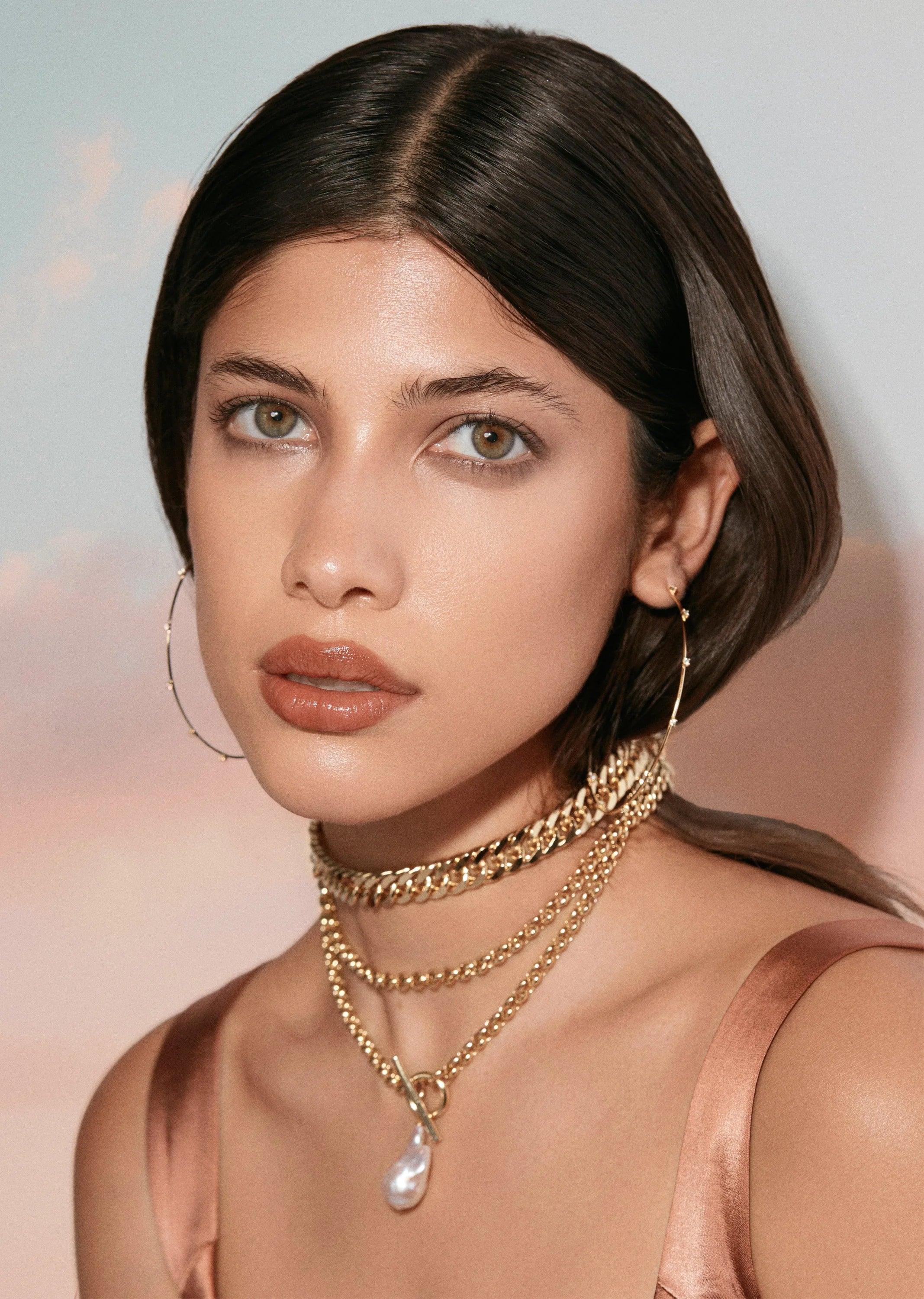 Woman wearing stylish 14k gold vermeil sterling silver earrings from CZ Studded Hoops