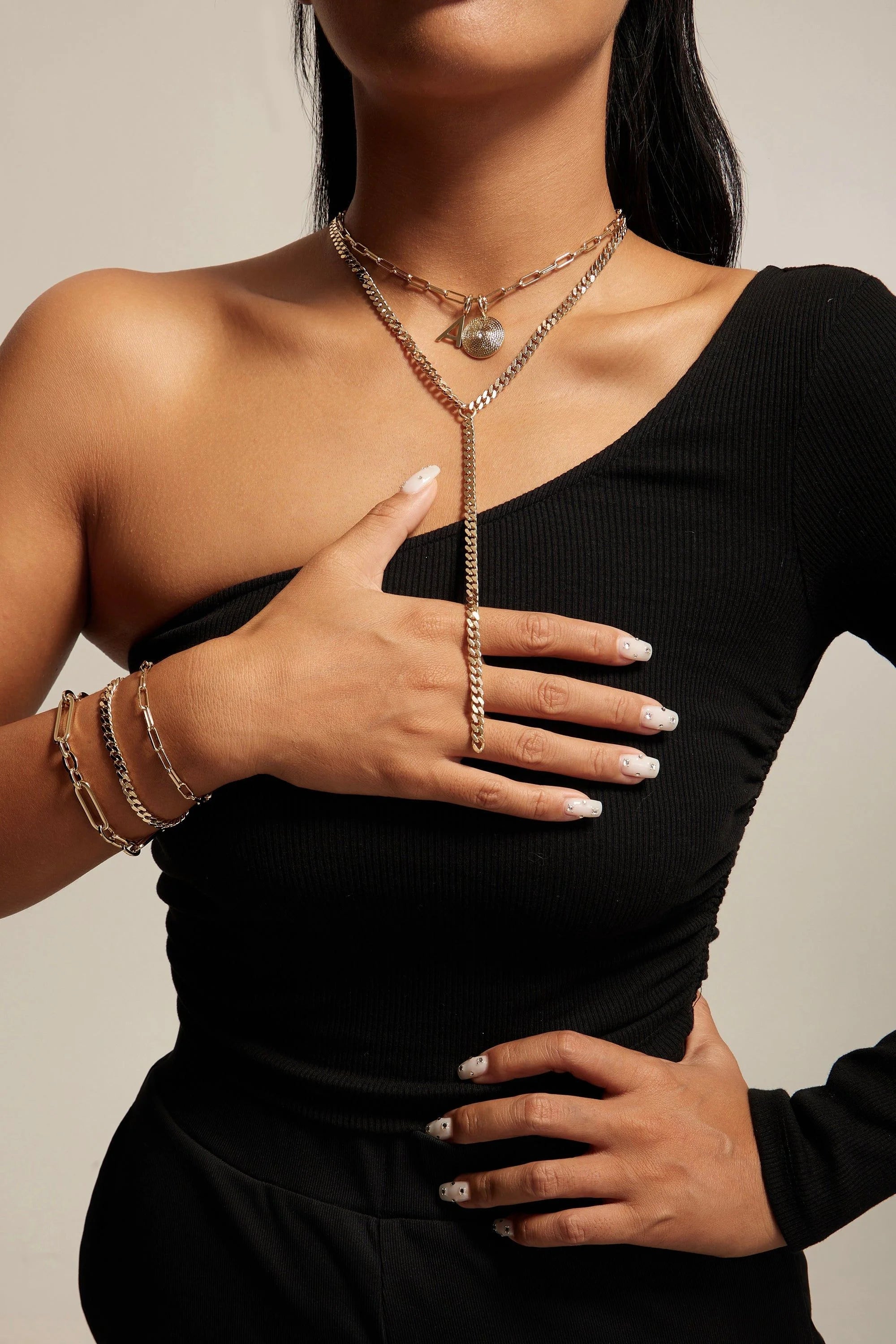 Gold-toned layered necklace and bracelet set featuring the Dean Bracelet with a large multi link chain