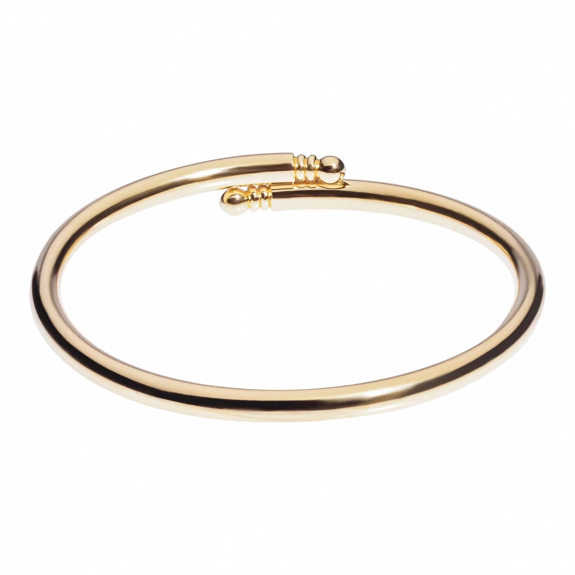 Gold-colored open-ended brass bangle from the Knob Ended Bangle collection