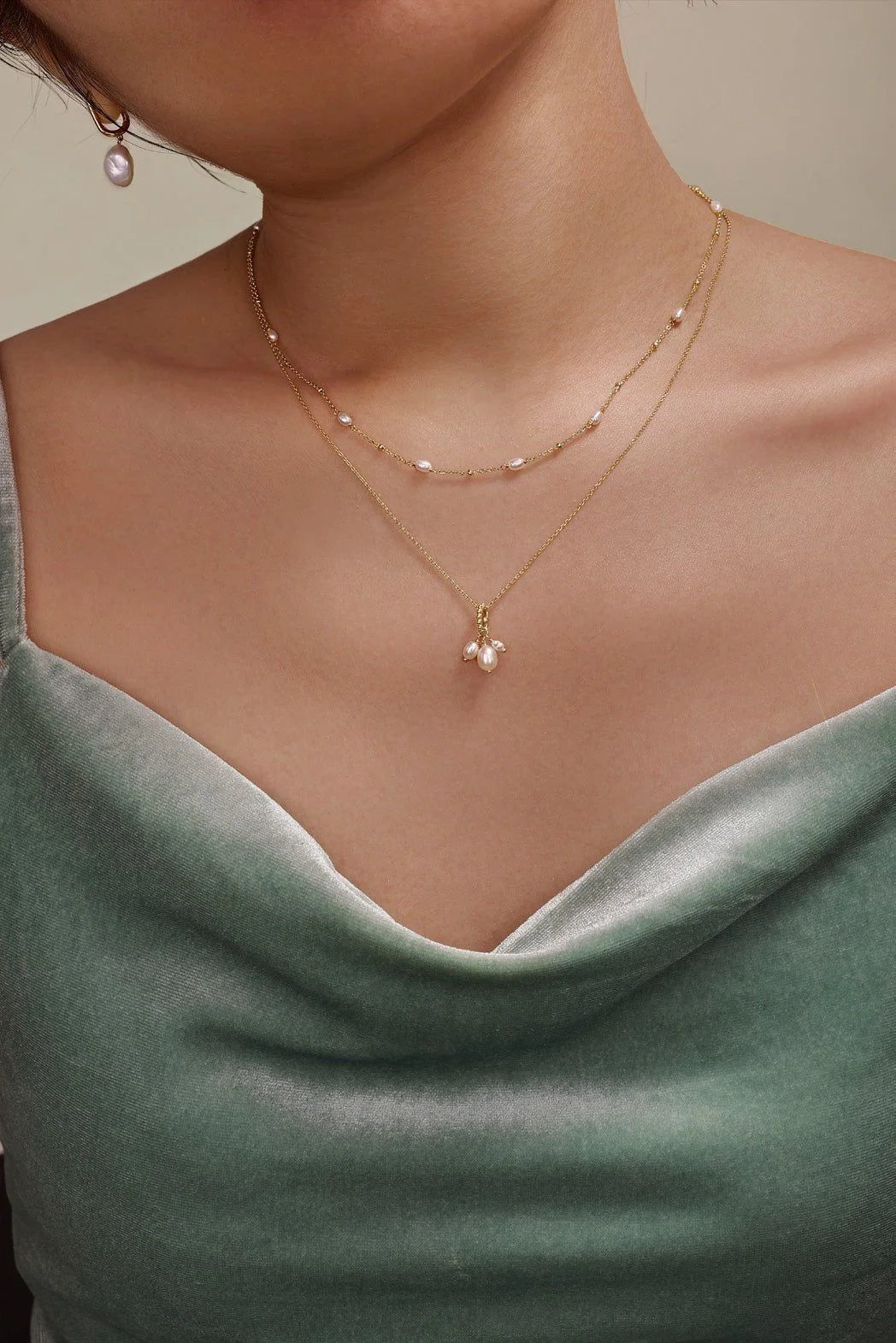Woman wearing layered 14k gold vermeil necklace with pearl beads and adjustable length