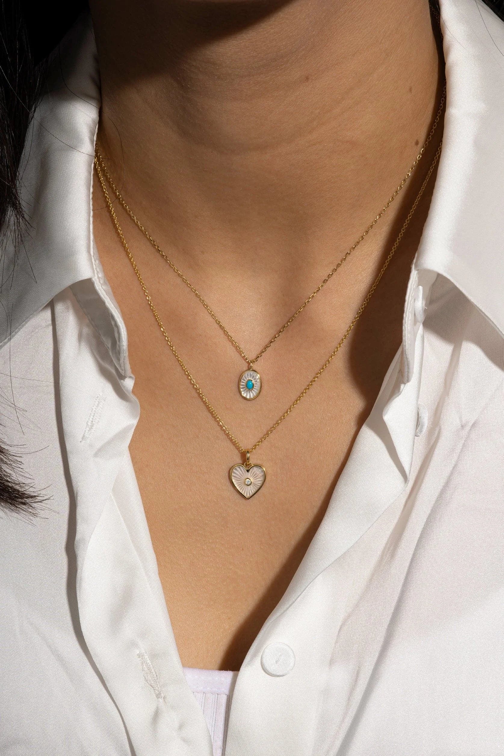 Two 14k gold necklaces with turquoise stone pendants and sterling silver accents