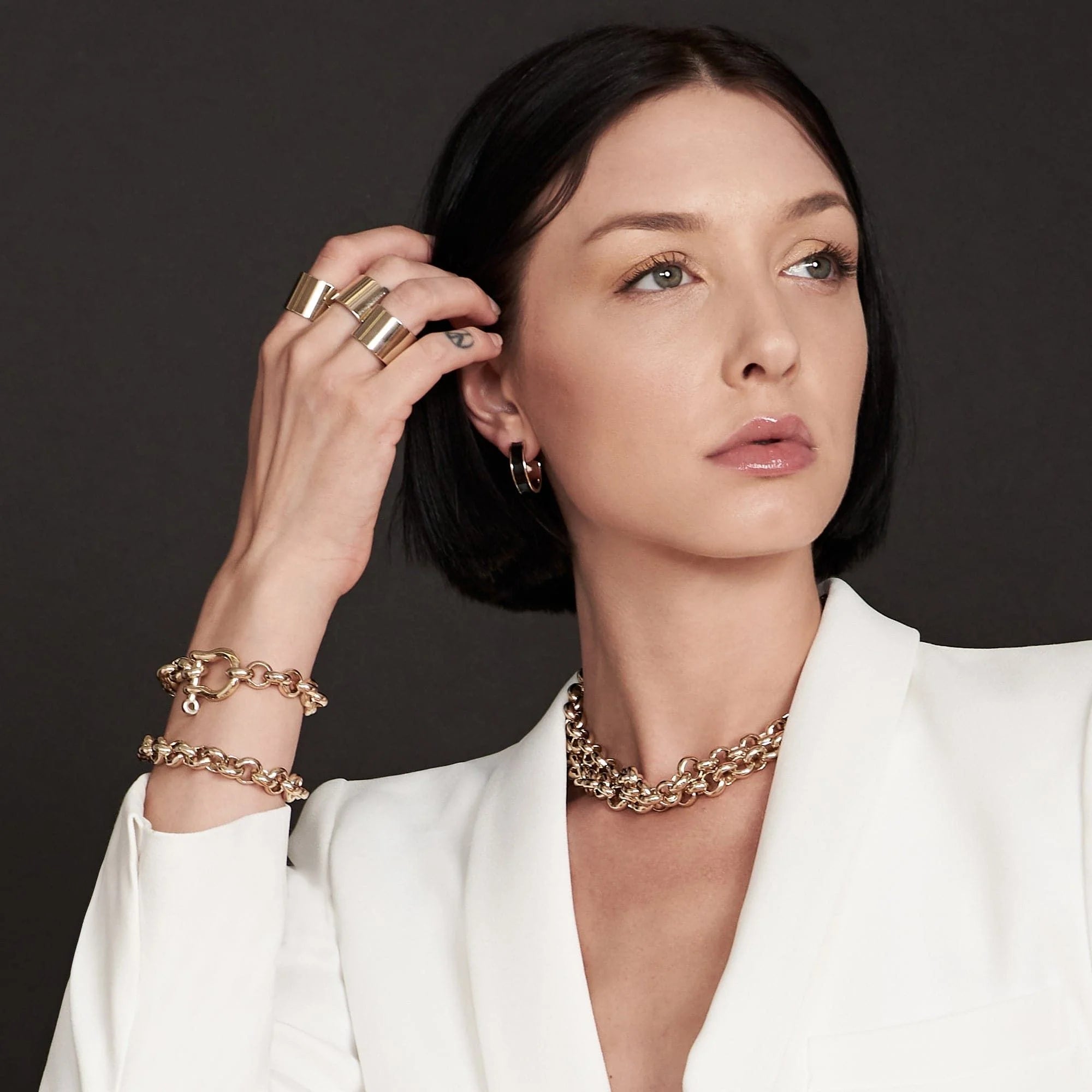 Woman wearing royal bracelet made of recycled brass and 14k gold jewelry