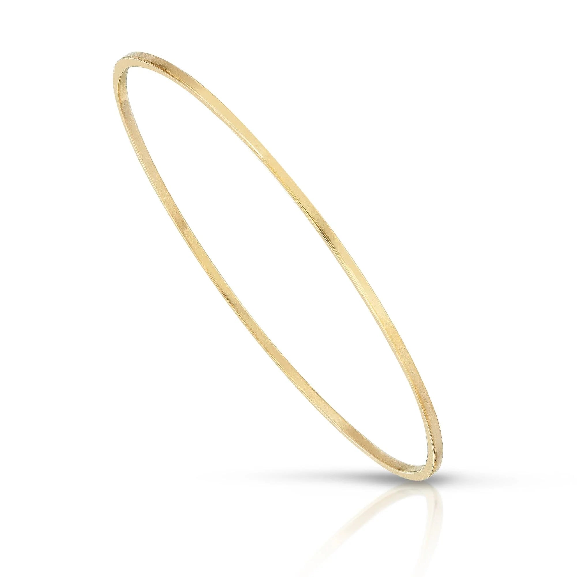 Slim gold brass wire Skinny Stella Bangle jewelry accessory on white background